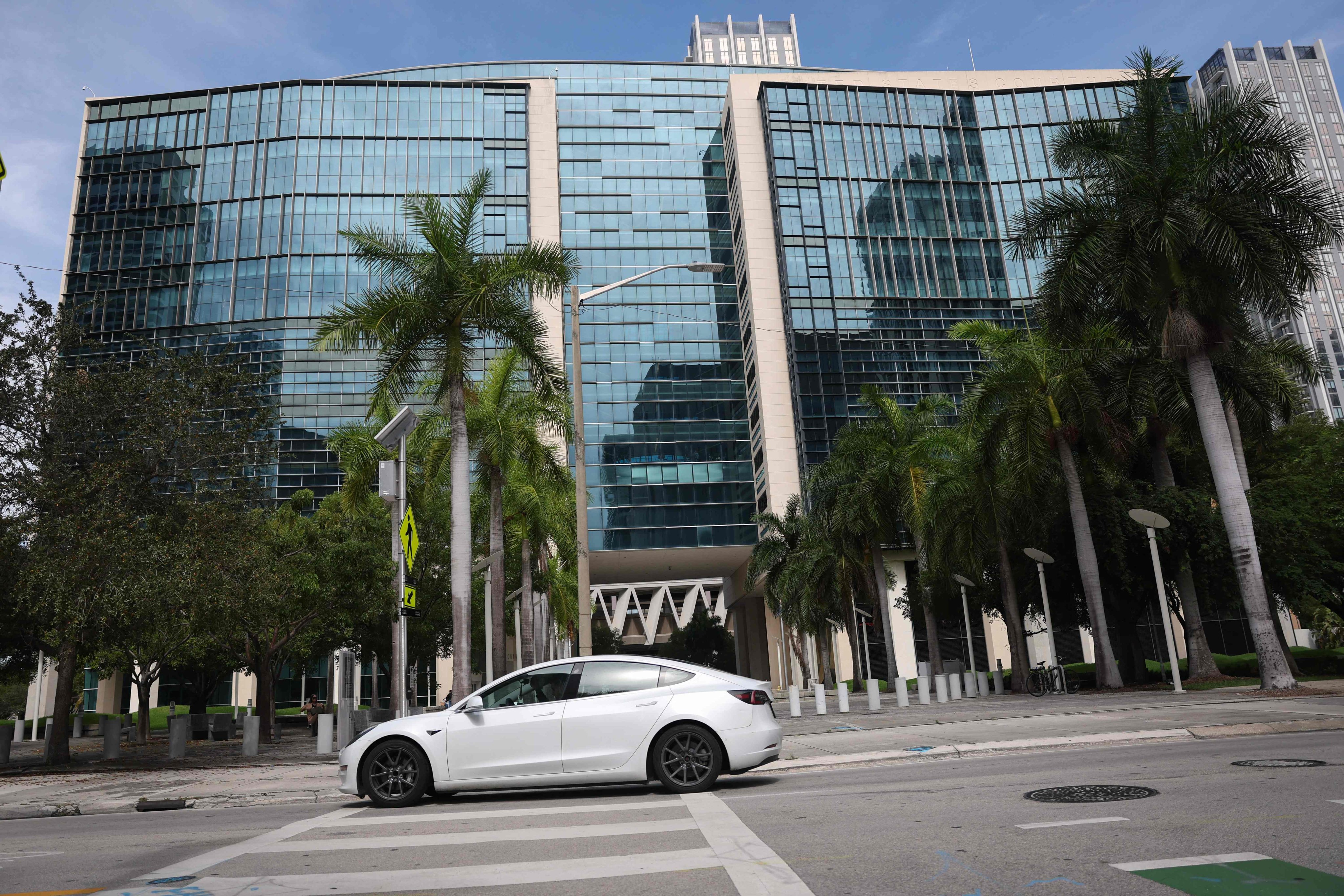 A Tesla vehicle passes the Wilkie D. Ferguson Jr US Courthouse as jury selection began in connection with allegations regarding the safety of Tesla’s autopilot system on July 14, 2025 in Miami, Florida. Photo: Getty Images via AFP