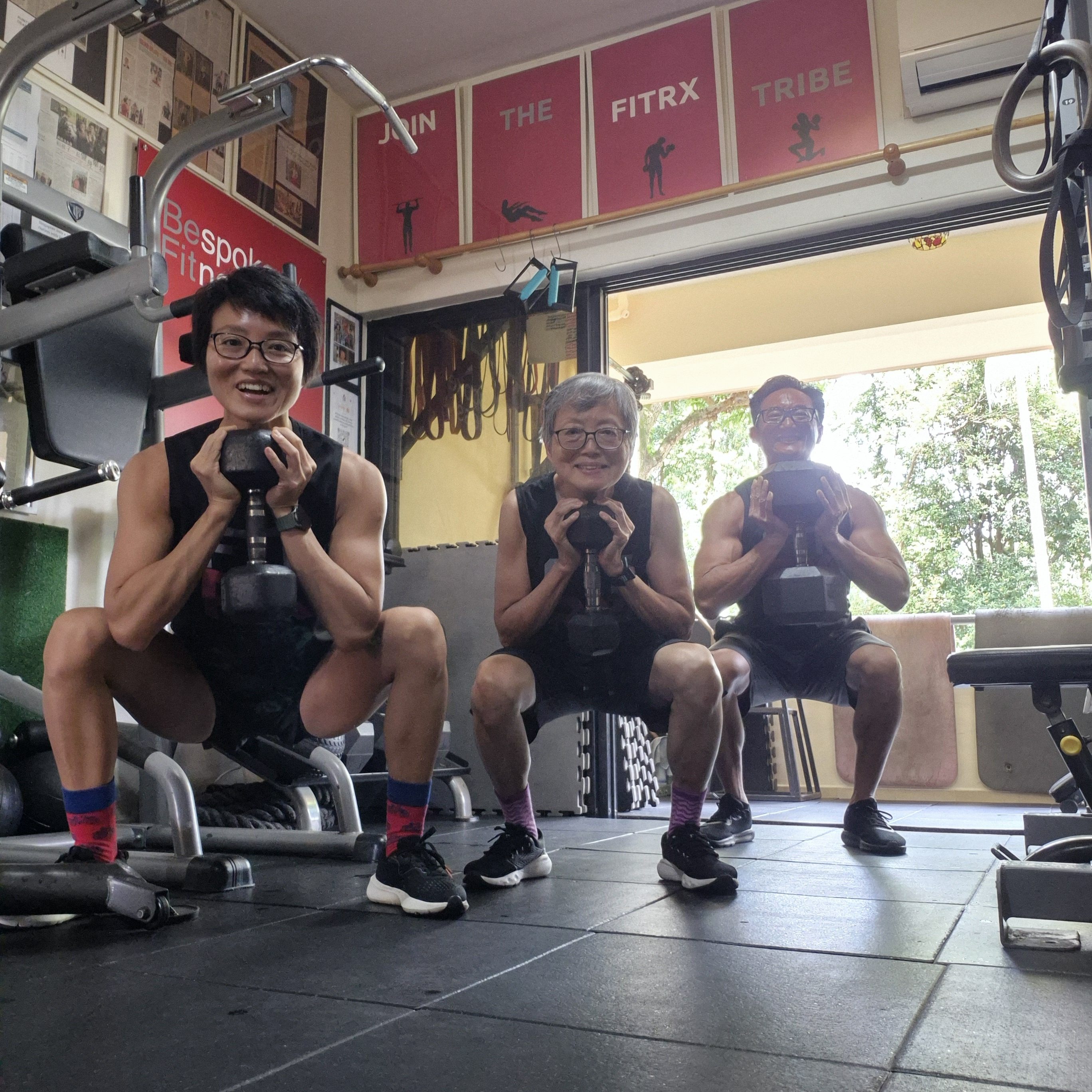 Charlotte Lim at the gym with her children, Yan Lin (left) and Tiat Lim. Known affectionately as “Pull-up Grandma” or “Auntie C”, the retired anthropologist is stronger and fitter than most people half her age. Photo: Instagram/coachwhy_yan