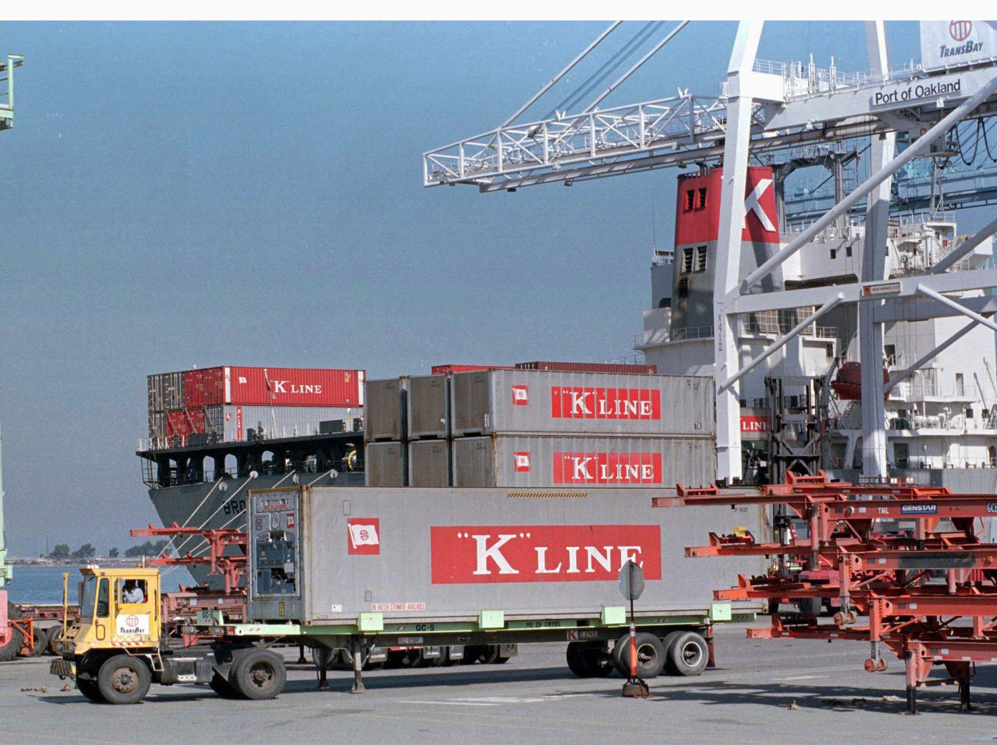 A truck carrying a cargo container belonging to the Japanese-owned K Line shipping company passes is loaded in the Oakland Harbour. Photo: Reuters