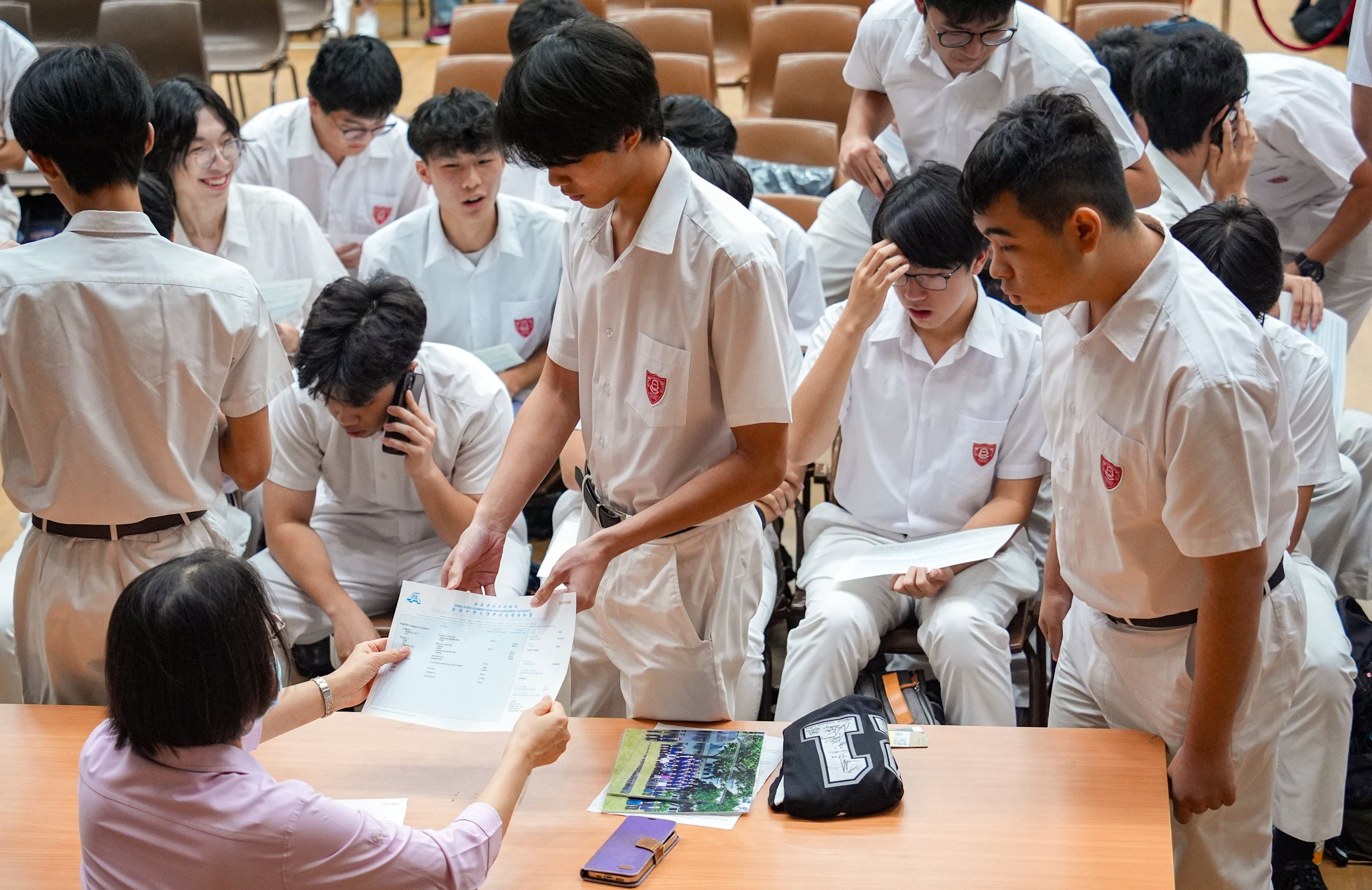 Queen’s College students are handed their DSE results. Photo: Eugene Lee