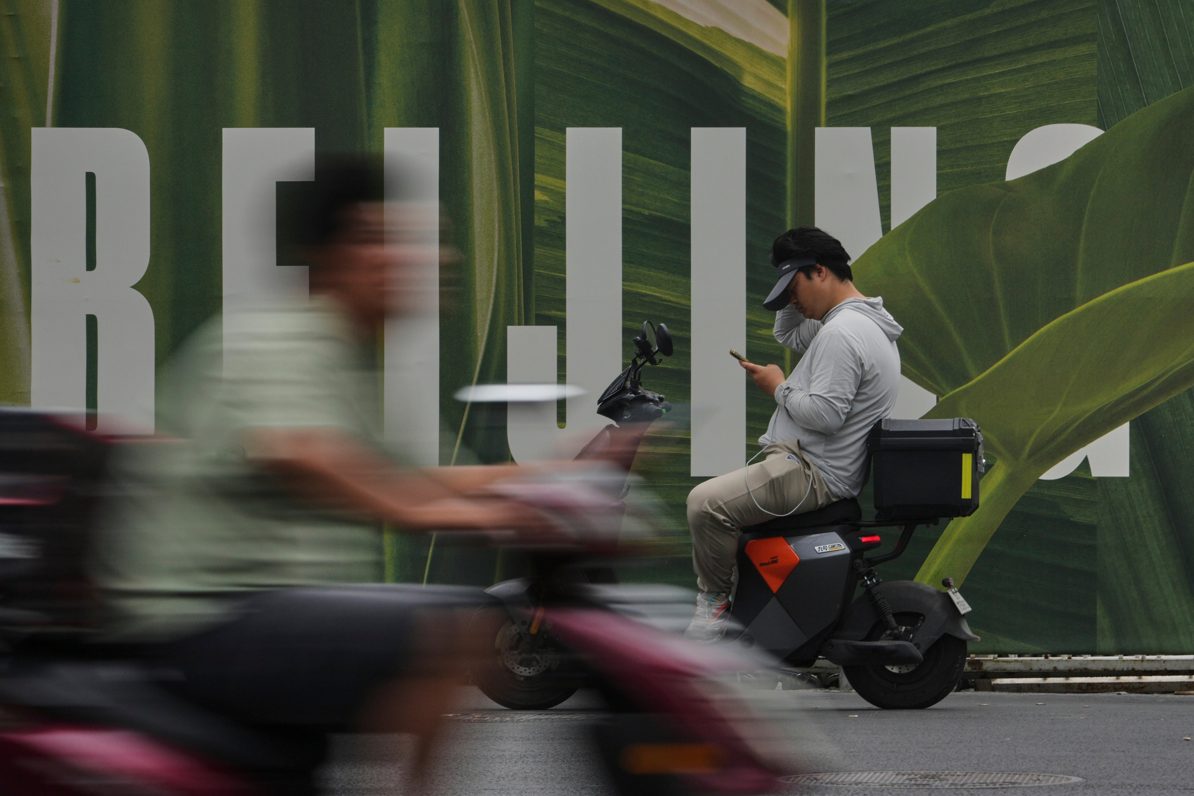 Delivery riders seen in Beijing. Photo: AP Photo