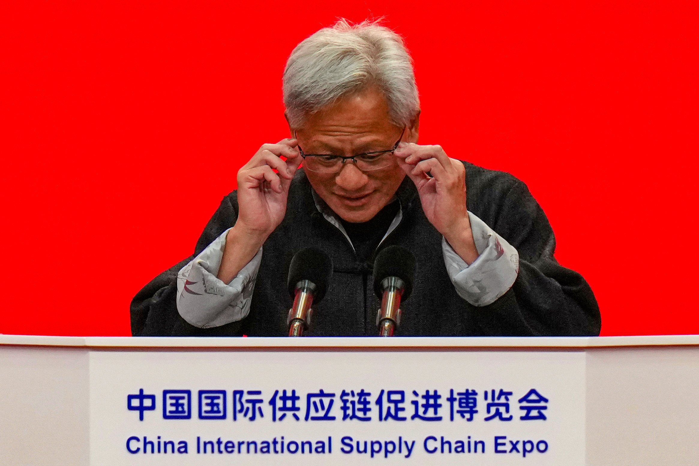 CEO of Nvidia Jensen Huang adjusts his glasses as he speaks on stage during the opening ceremony of the 3rd China International Supply Chain Expo, in Beijing. Photo: AP