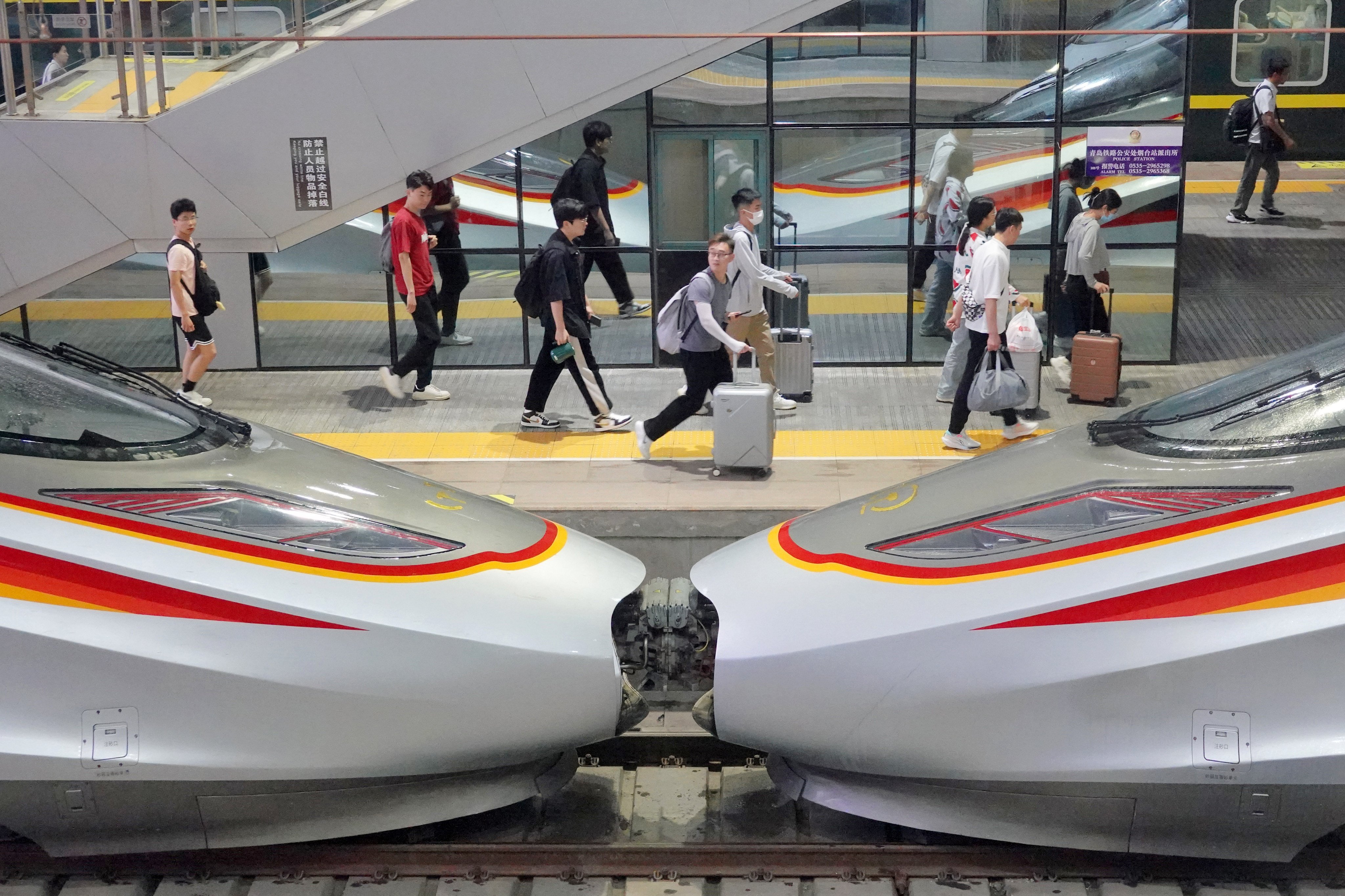 Passengers walk along a platform at the Yantai Railway Station in Shandong province on July 1. China’s high-speed railway lines span nearly 50,000km (31,000 miles). Photo: Getty Images