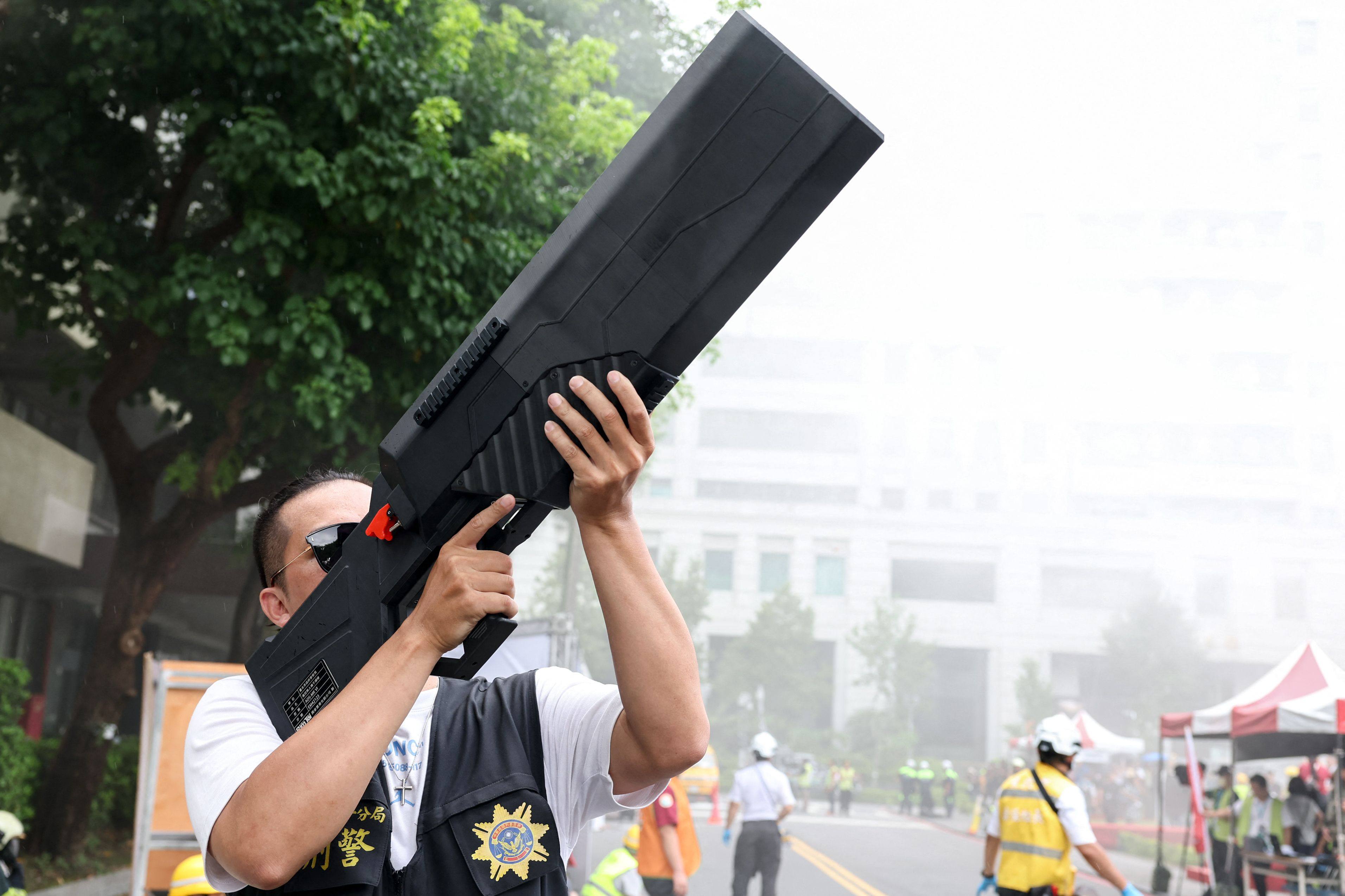 A participant uses an anti-drone weapon while taking part in a mass casualty evacuation drill during the annual Han Kuang military exercises in Taipei, Taiwan on Thursday. Photo: AFP