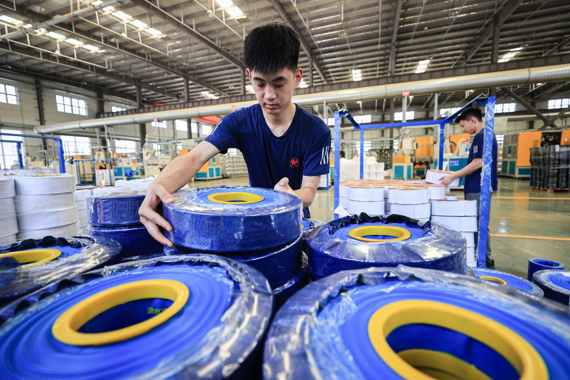 An employee works on a production line of tubular products for export at a factory in Lianyungang, in eastern China’s Jiangsu province on July 8. Photo: AFP An employee works on a production line of tubular products for export at a factory in Lianyungang, in eastern China’s Jiangsu province on July 8. Photo: AFP