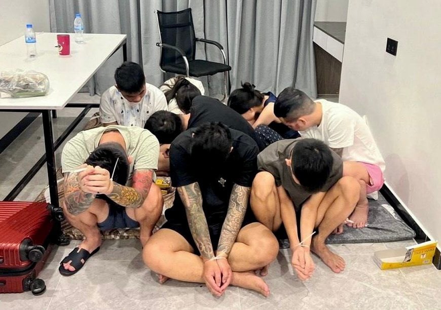 Suspects are seen with their hands tied after being detained during a police raid on a scam centre in Phnom Penh, Cambodia on Wednesday. Photo: EPA