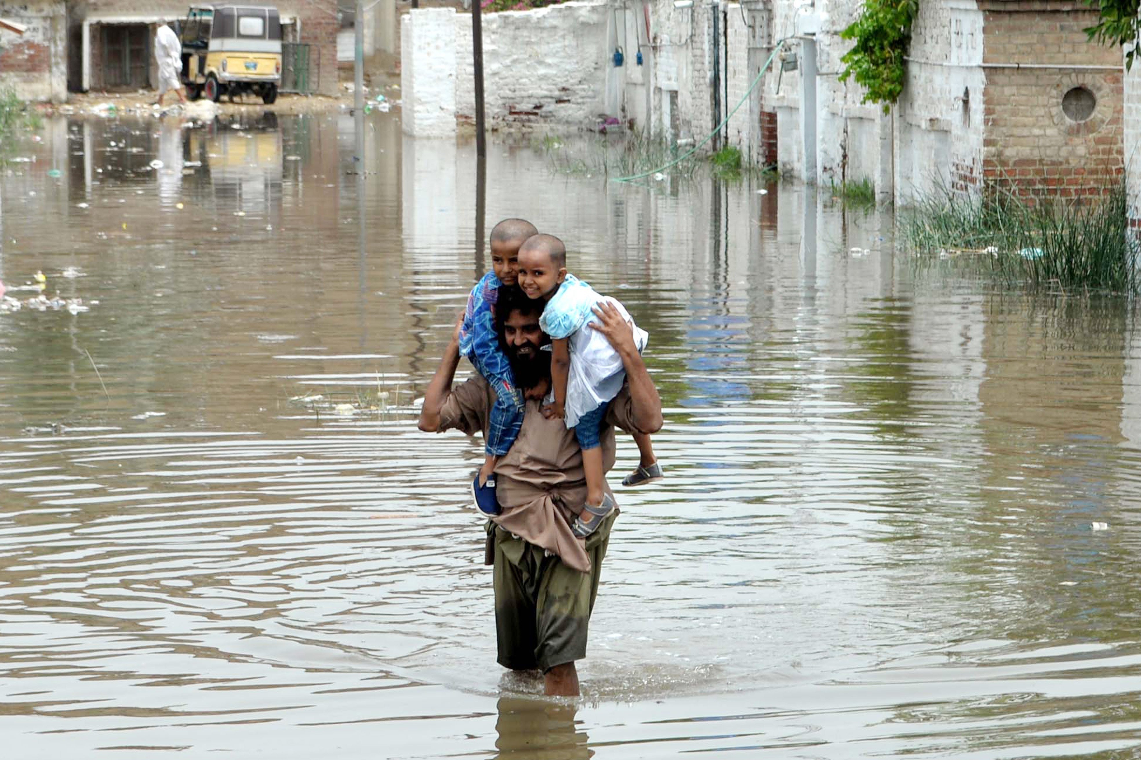 A man wades through floodwater after heavy monsoon rains in southern Pakistan’s Hyderabad on July 15. Photo: Xinhua