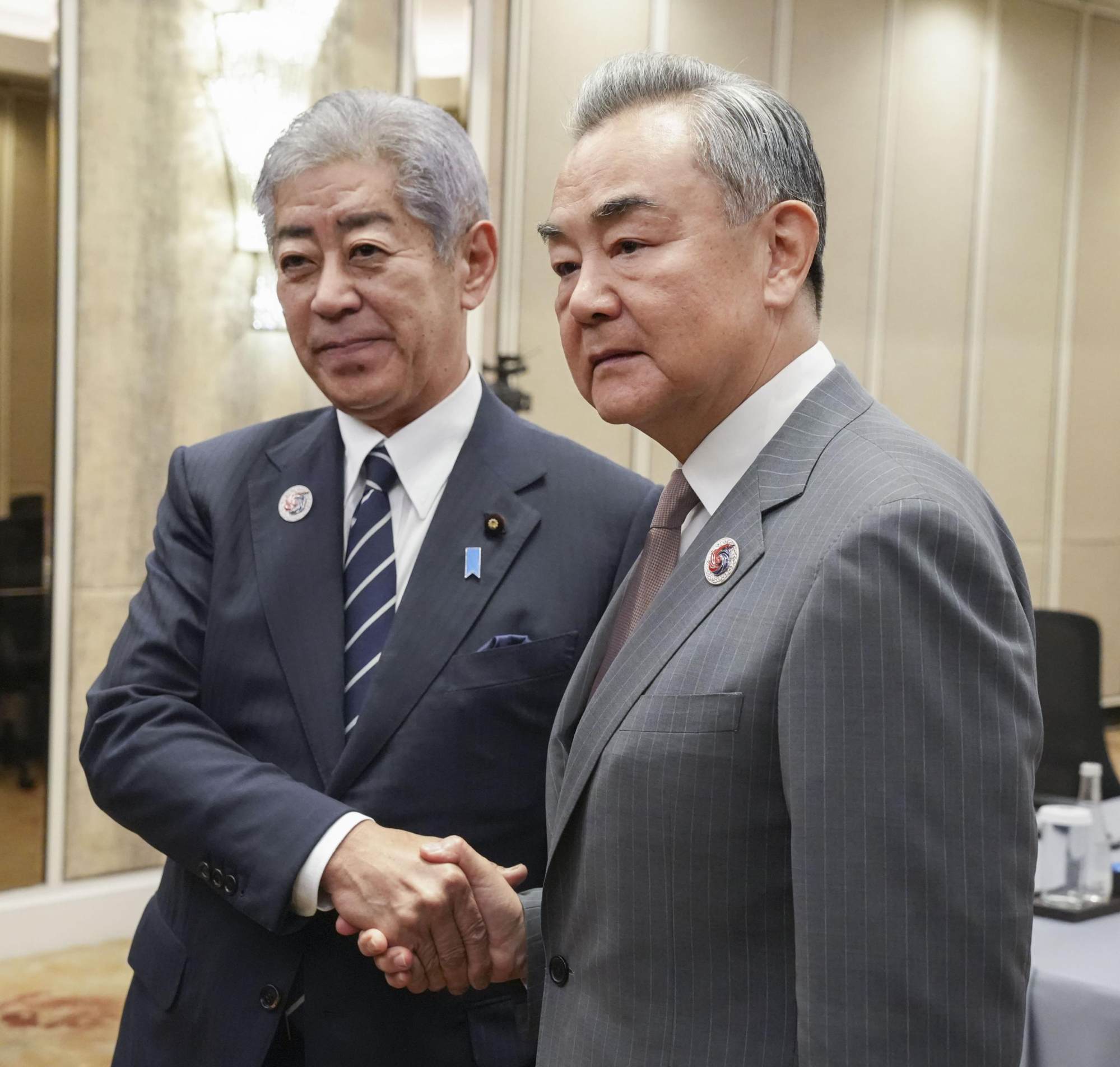 China’s Foreign Minister Wang Yi shakes hands with his Japanese countepart Takeshi Iwaya (left) ahead of their talks in Kuala Lumpur on July 10 on the sidelines of an Asean summit. Photo: Kyodo