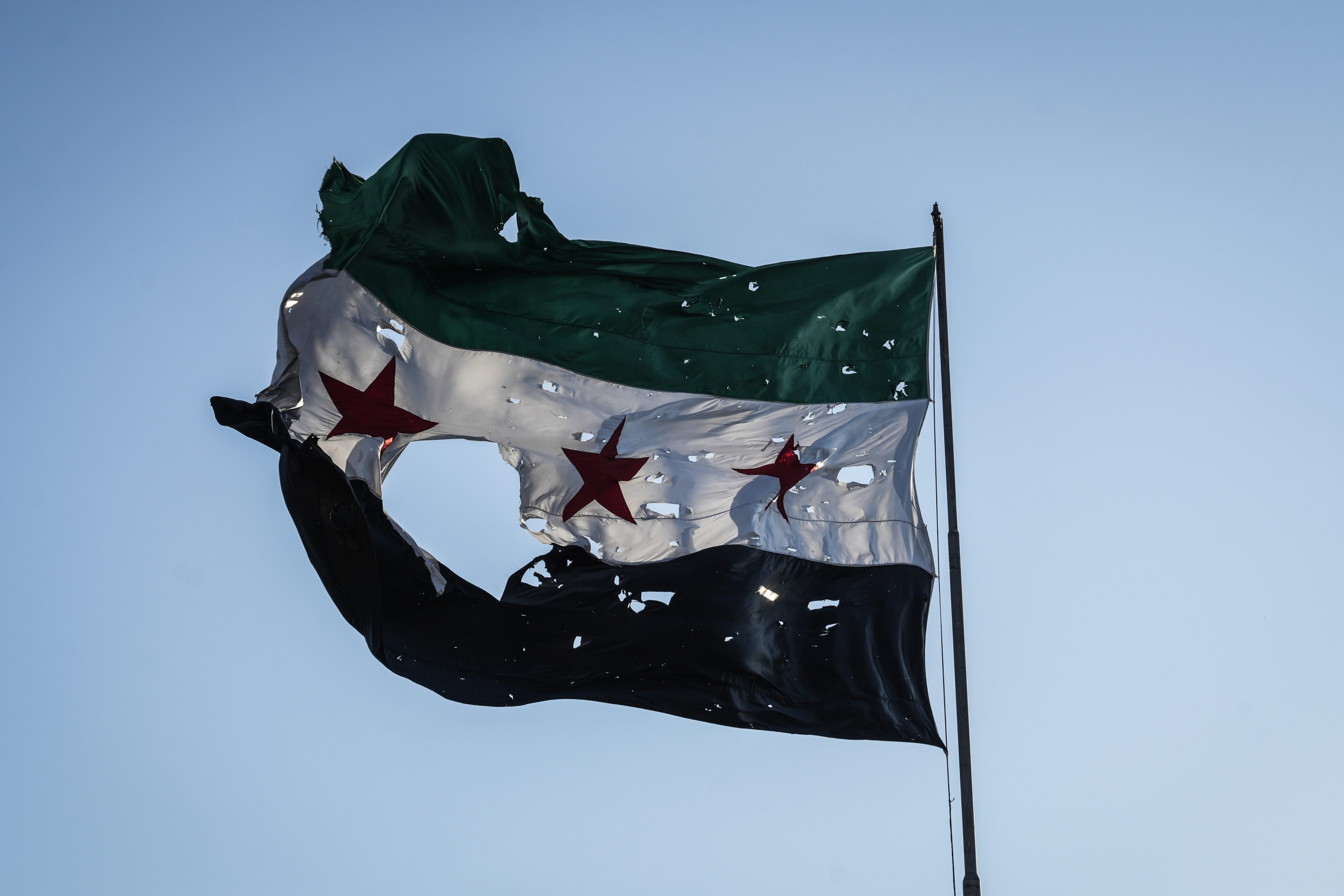 A tattered Syrian flag at the Syrian general staff headquarters after it was hit by Israeli airstrikes on Damascus. Photo: dpa