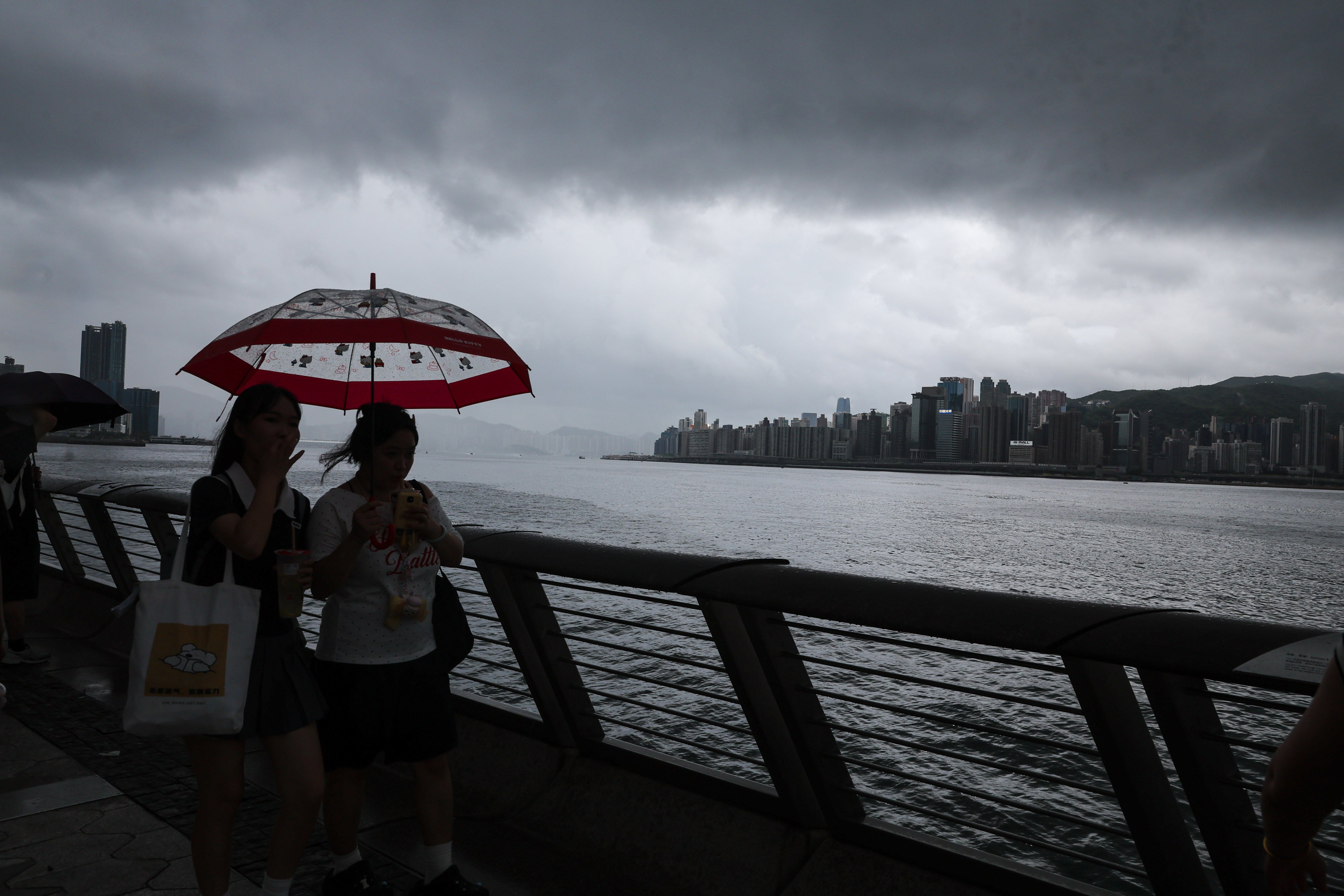 Tourists walk along the Avenue of Stars under last week’s storm clouds. Photo: Edmond So
