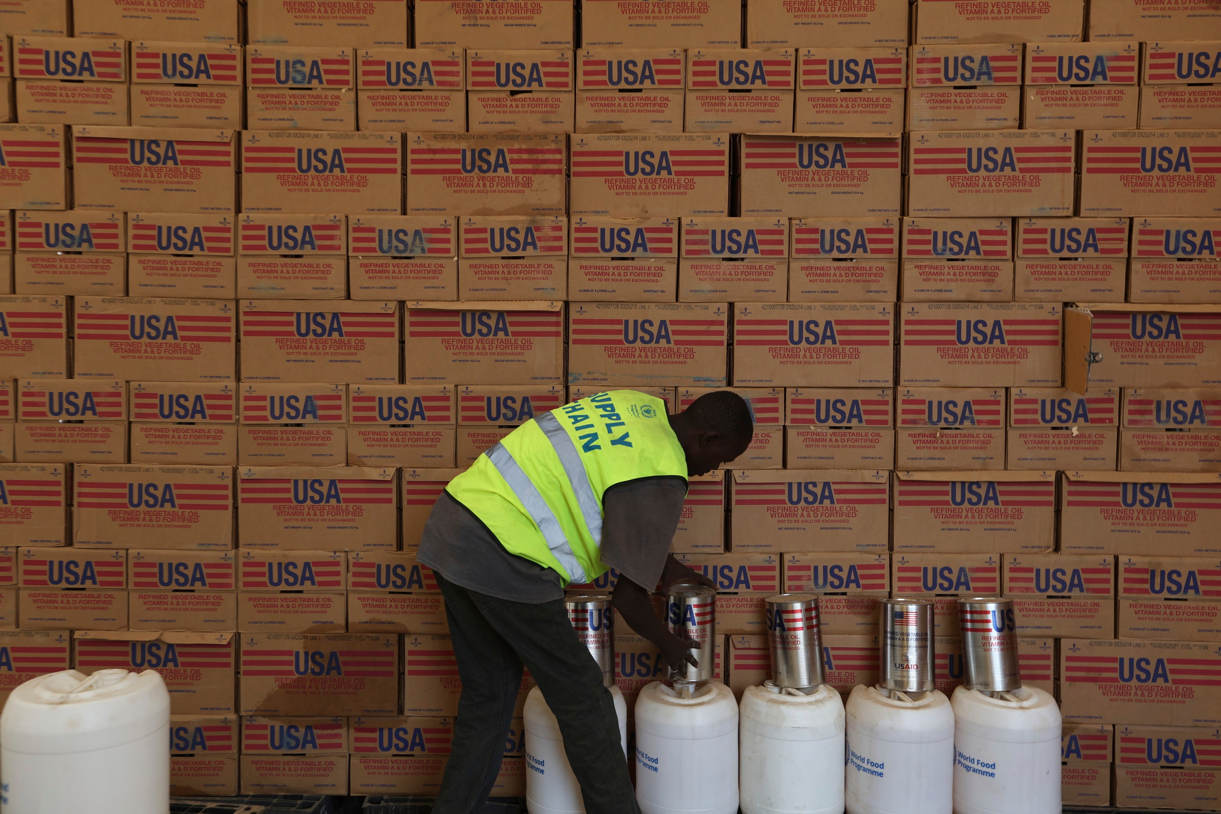 A man arranges USAID humanitarian aid inside a warehouse run by the World Food Programme (WFP) at Kakuma Refugee Camp in Turkana, Kenya. Photo: AP