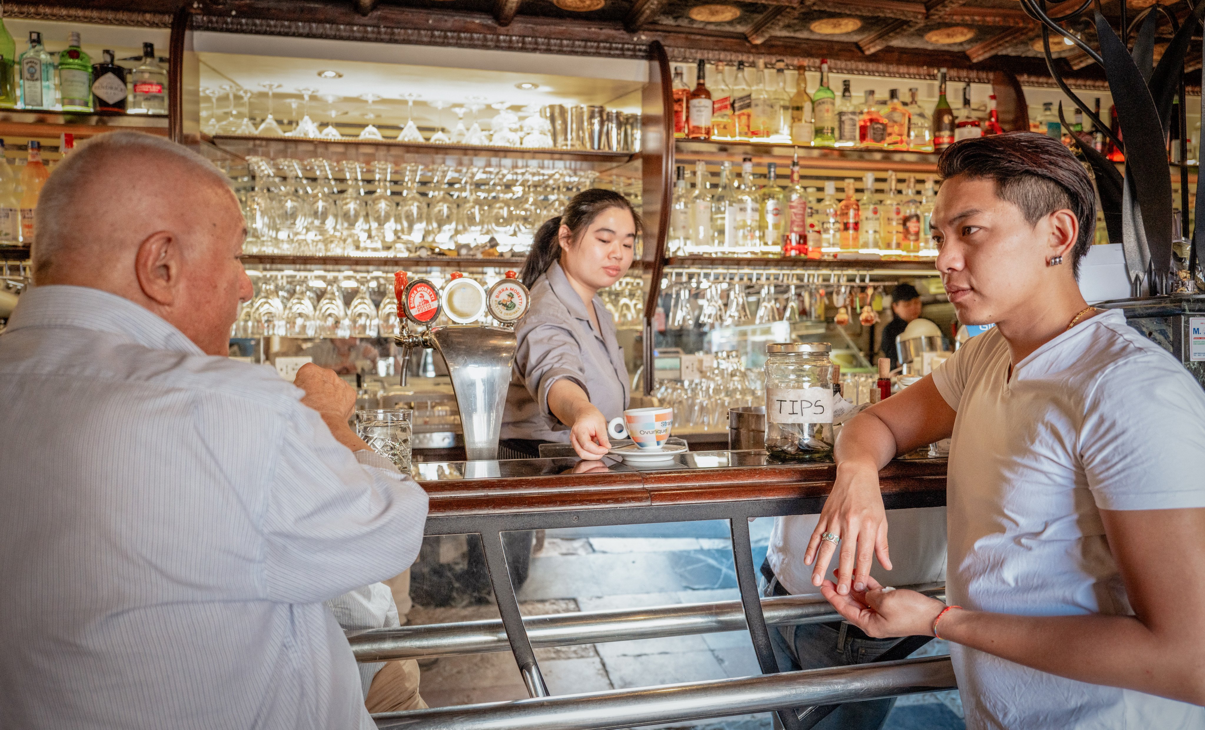 Lin Yichen (right), owner of Venice’s Bar Foscarini, and barista Sophia with cafe regular Claudio Gatta. Photo: Federico Sutera