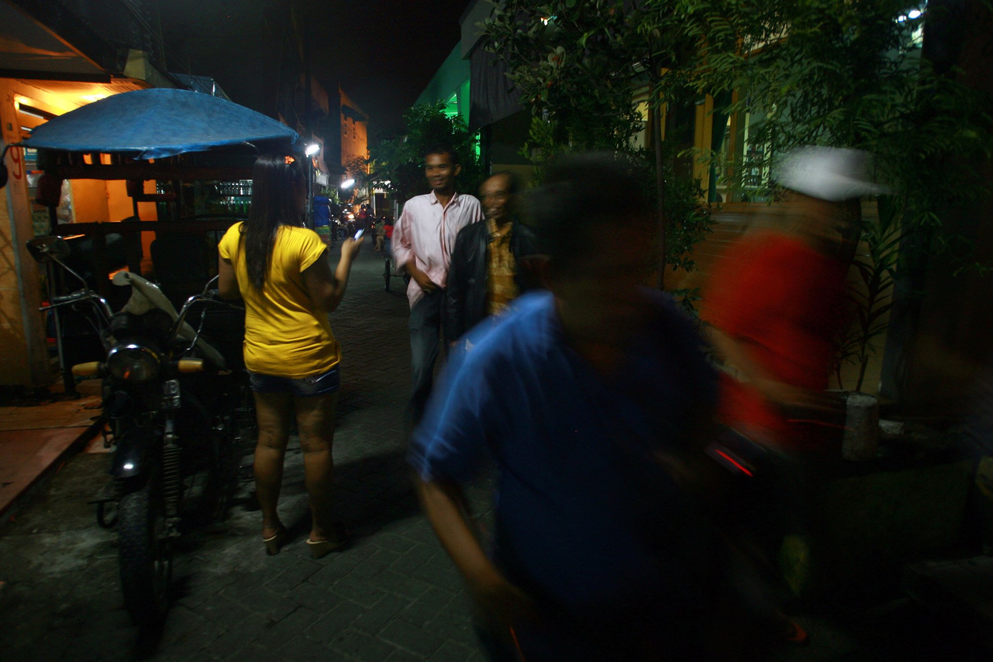 An Indonesian sex worker talks to prospective customers outside a brothel in a now-defunct red light district on Java island in 2014. Photo: AFP An Indonesian sex worker talks to prospective customers outside a brothel in a now-defunct red light district on Java island in 2014. Photo: AFP