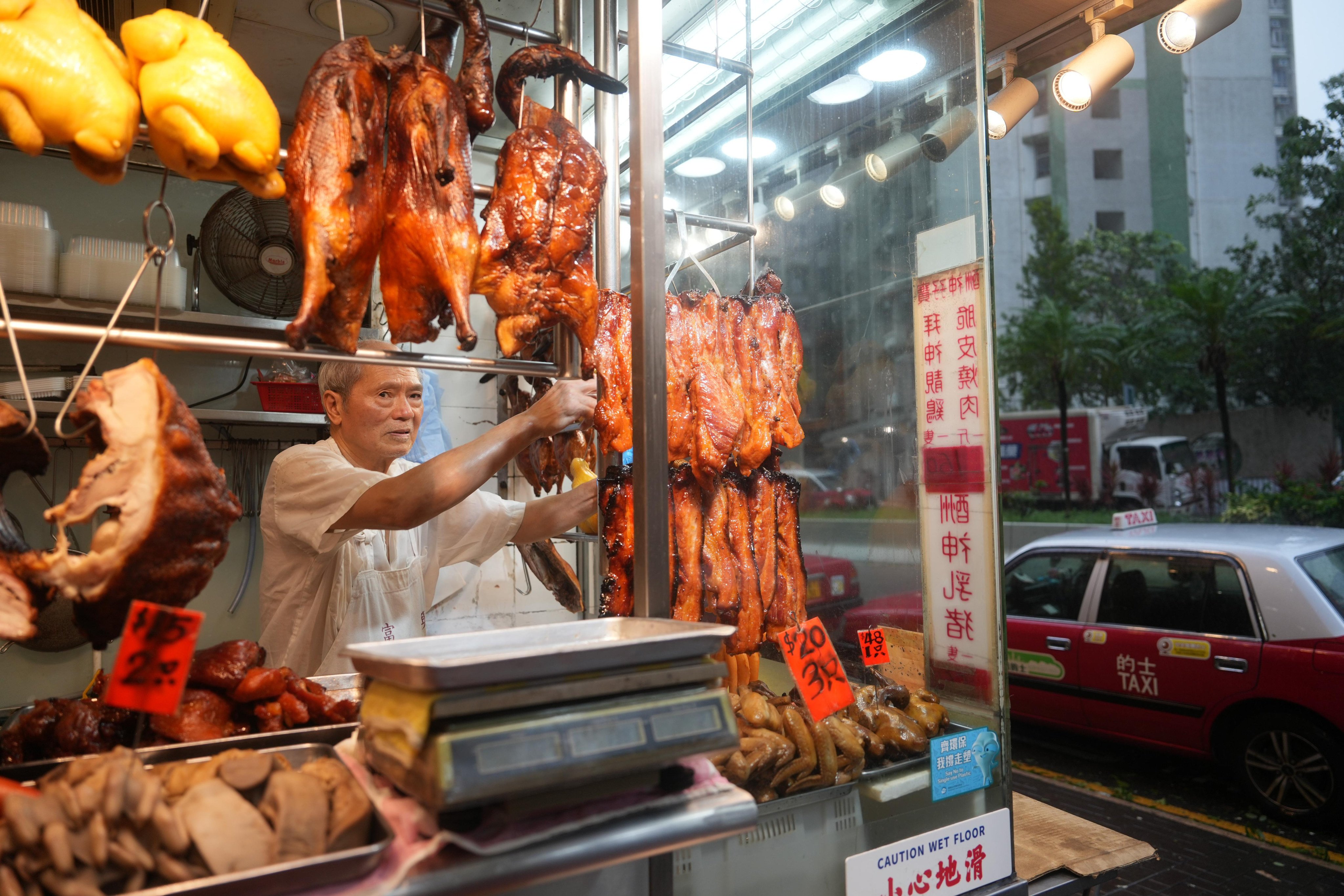 Many businesses and workers, including Lin Wing-fu, a chef of a restaurant at Siu Sai Wan, braved Typhoon Wipha. Photo: Sam Tsang