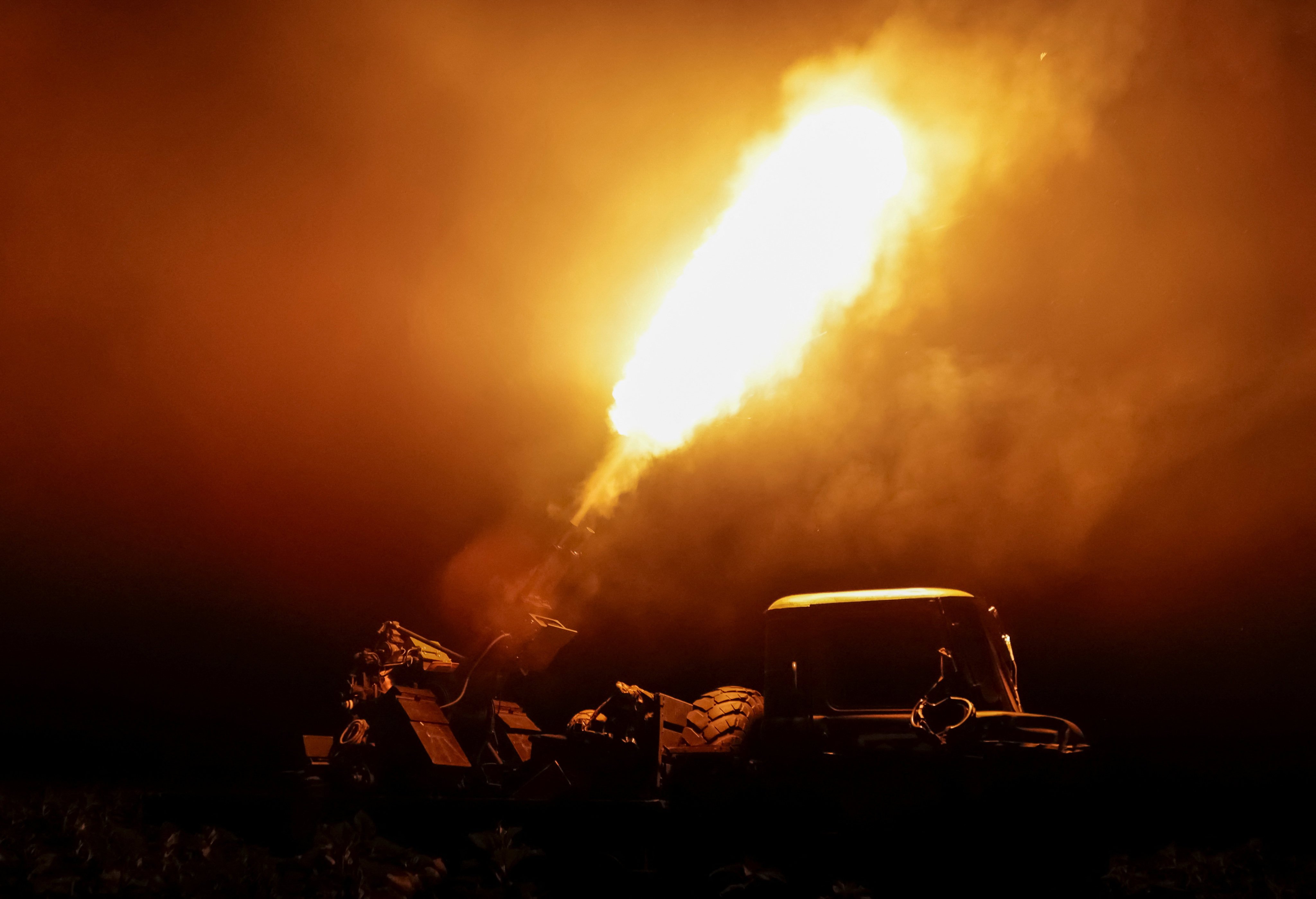 A Ukrainian serviceman fires an anti-aircraft machine gun towards a Russian drone in Kharkiv region, Ukraine, on Thursday. Photo: Reuters