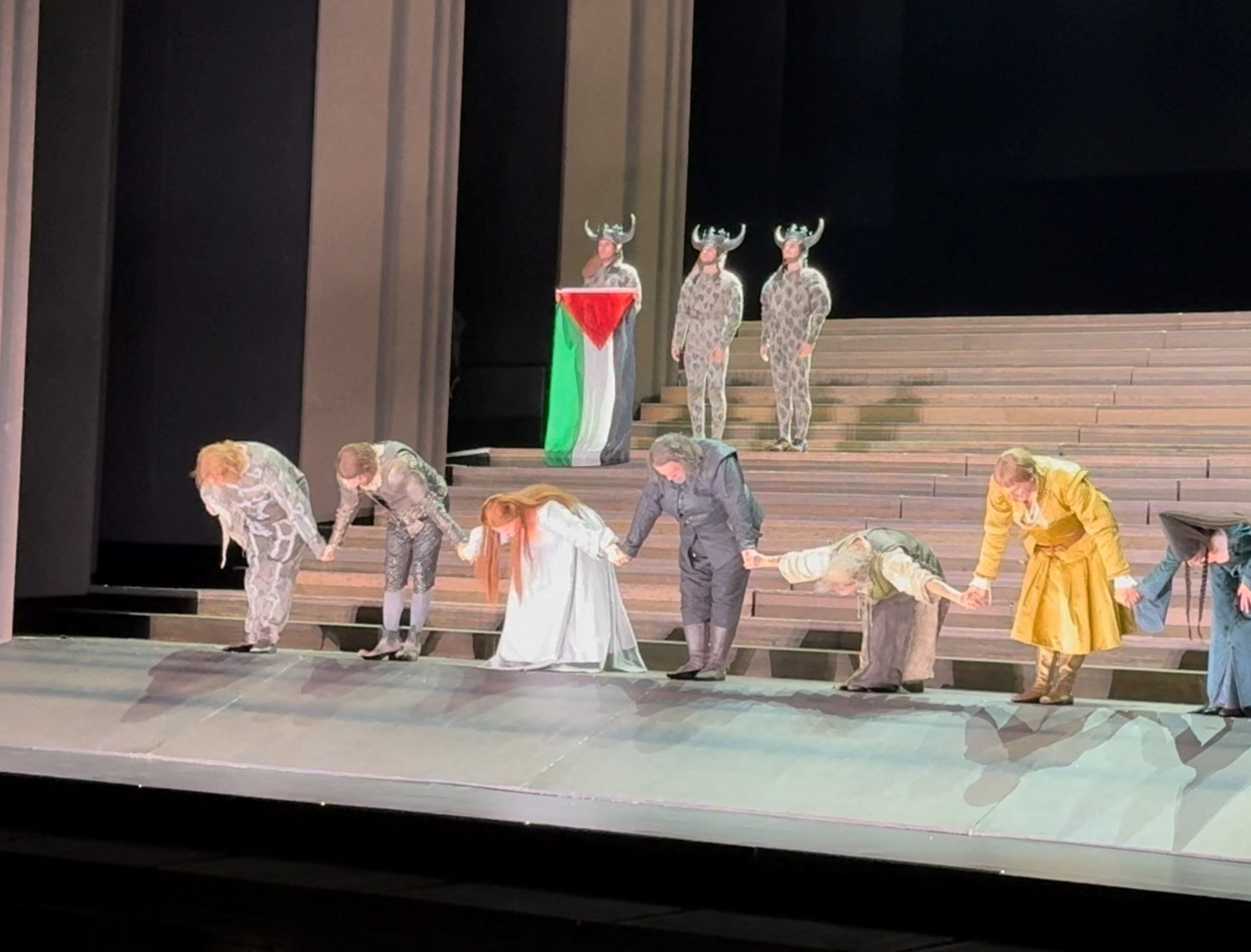 Cast members bow as one holds a Palestinian flag, during the curtain call of Il Trovatore at the Royal Opera House in Covent Garden, London, Britain on Sunday. Photo: @sydcas via Reuters