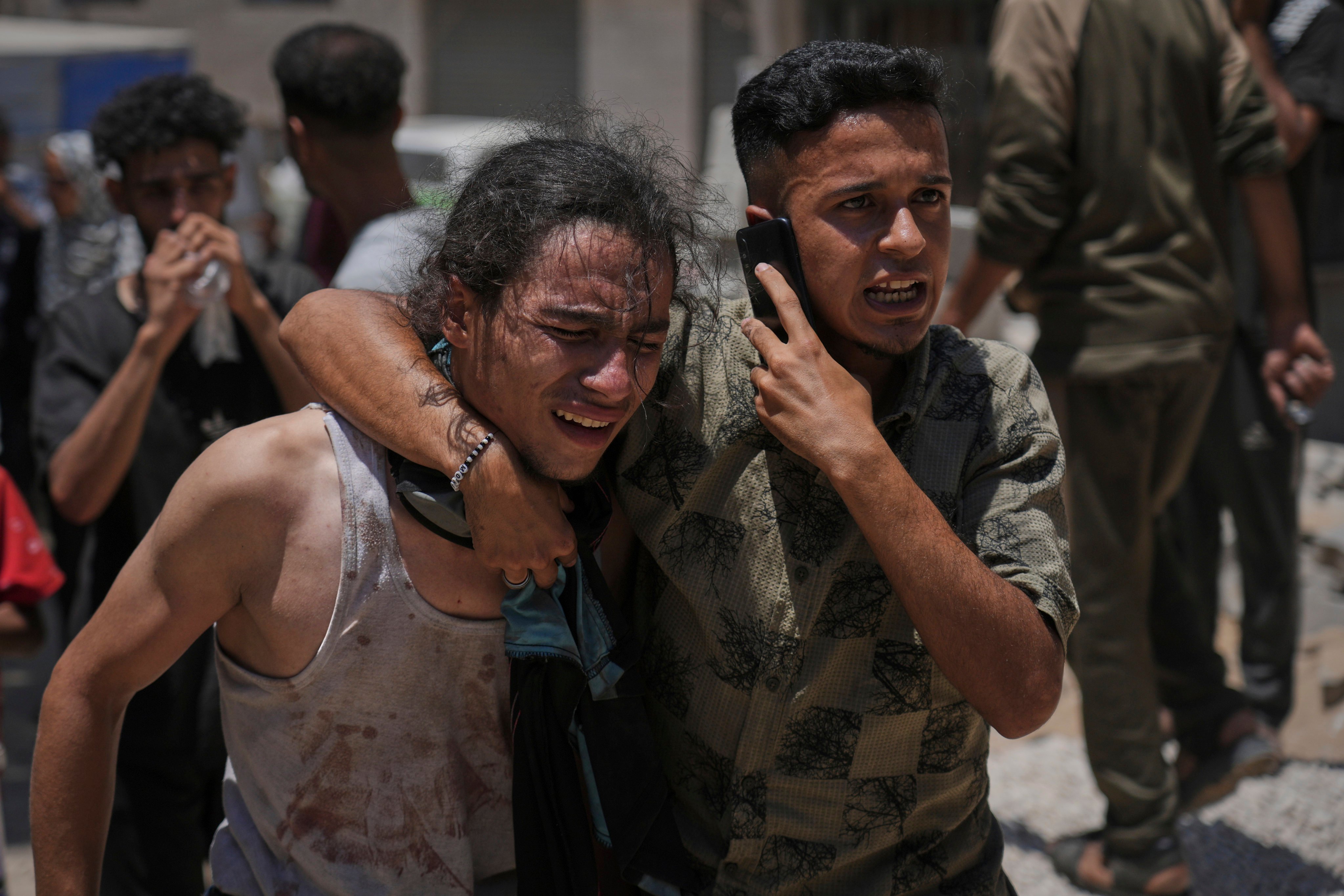 Palestinians after carrying the bodies of those killed while trying to reach aid trucks entering northern Gaza. Photo: AP