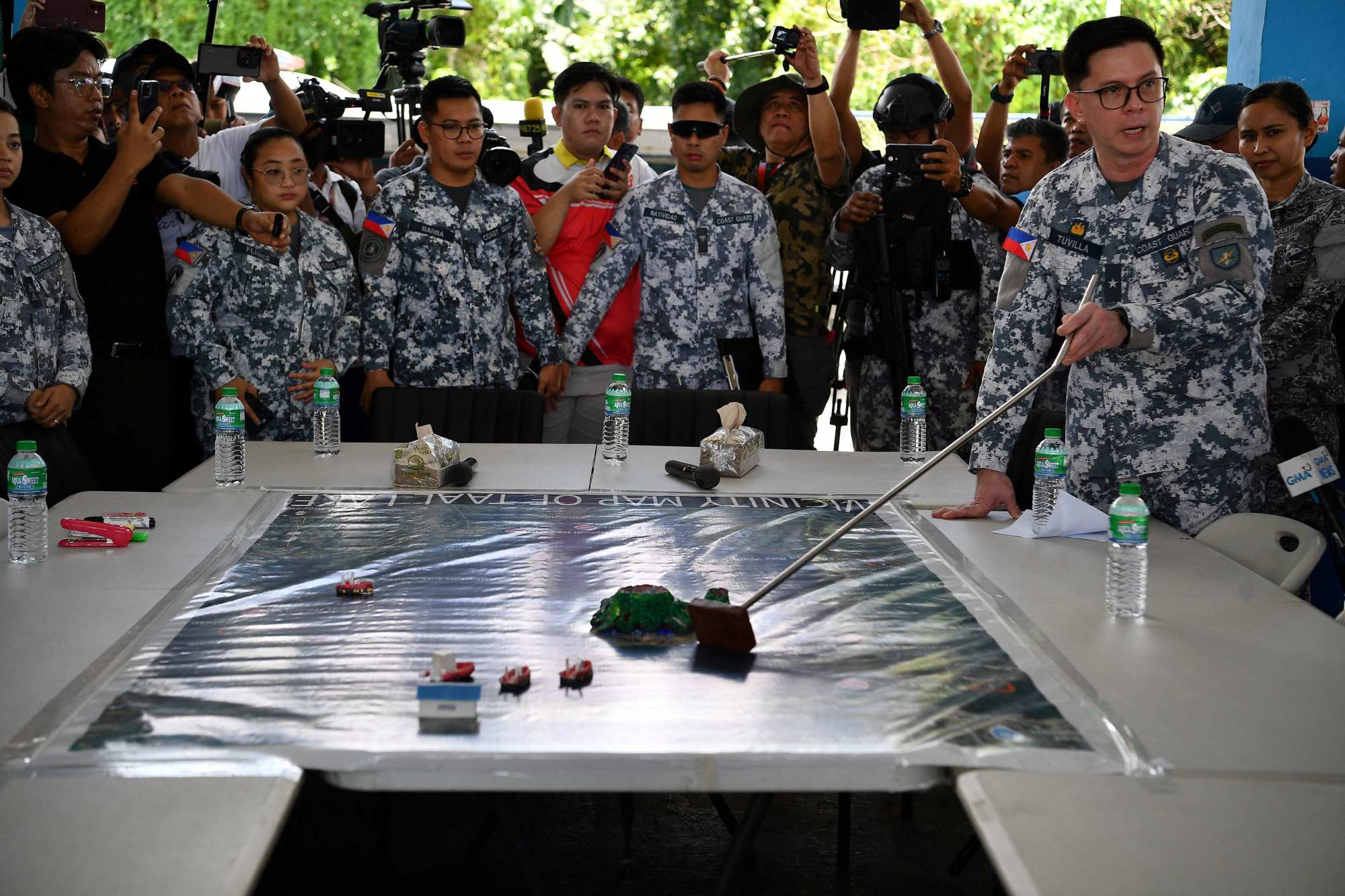 Philippine coastguard officials show a map of their search and retrieval operations in Taal Lake on July 10. Photo: AFP Philippine coastguard officials show a map of their search and retrieval operations in Taal Lake on July 10. Photo: AFP