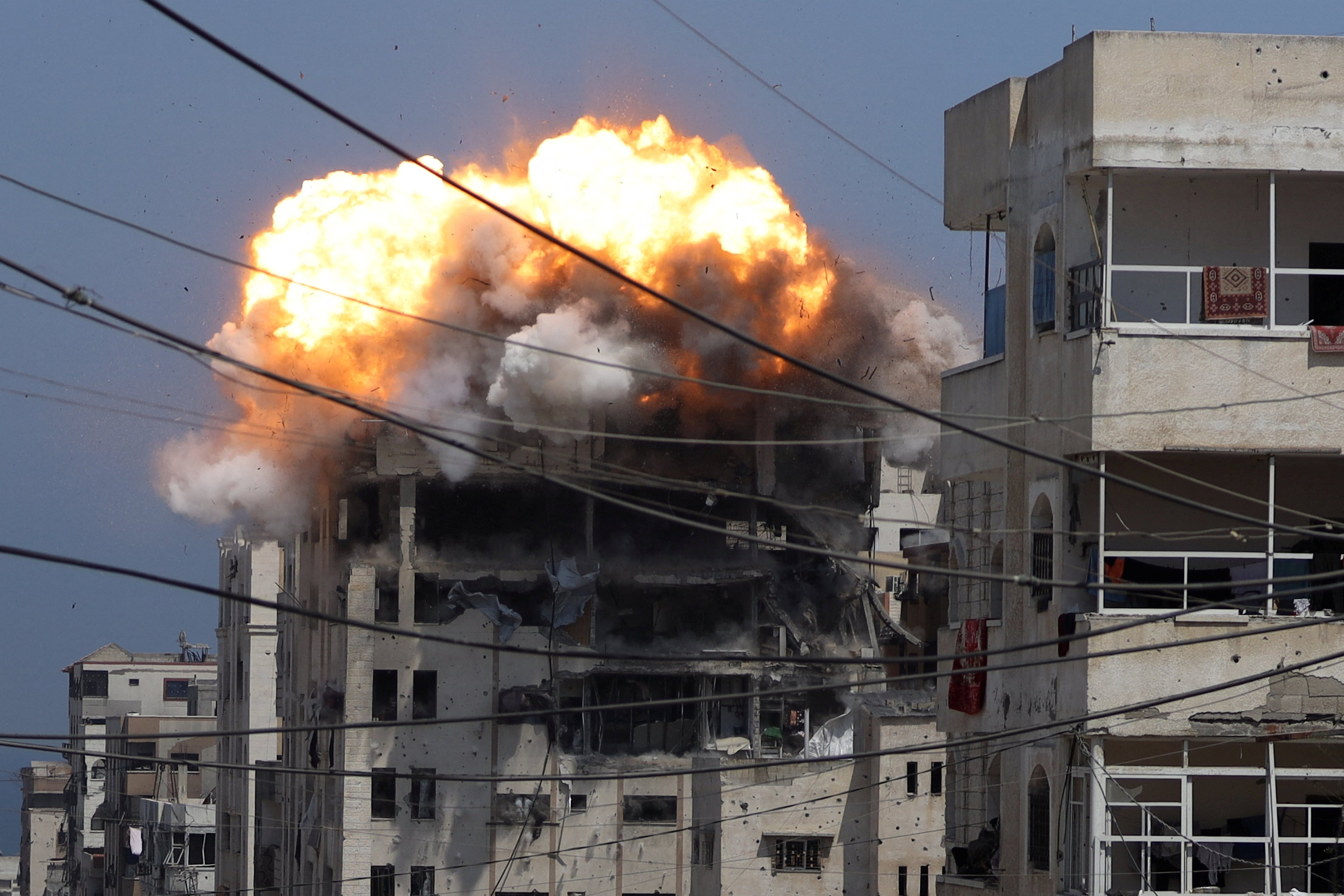 Smoke and flames rise from a residential building hit by an Israeli strike, in Gaza City on Monday. Photo: Reuters