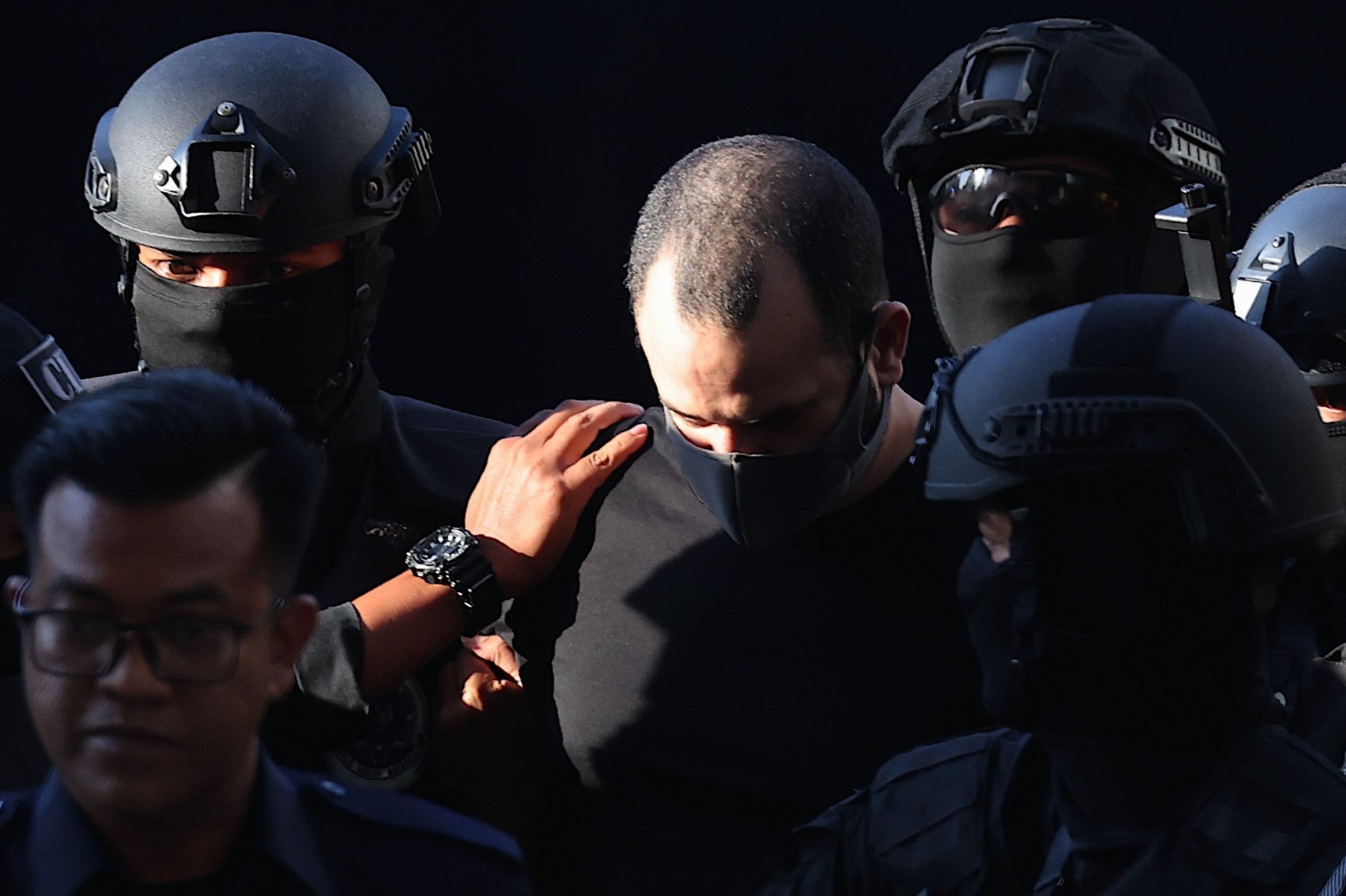 Israeli Shalom Avitan (centre) being escorted by Royal Malaysia Police officers to Kuala Lumpur Sessions Court on April 12, 2024. Avitan was sentenced to seven years’ jail in February. Photo: EPA-EFE