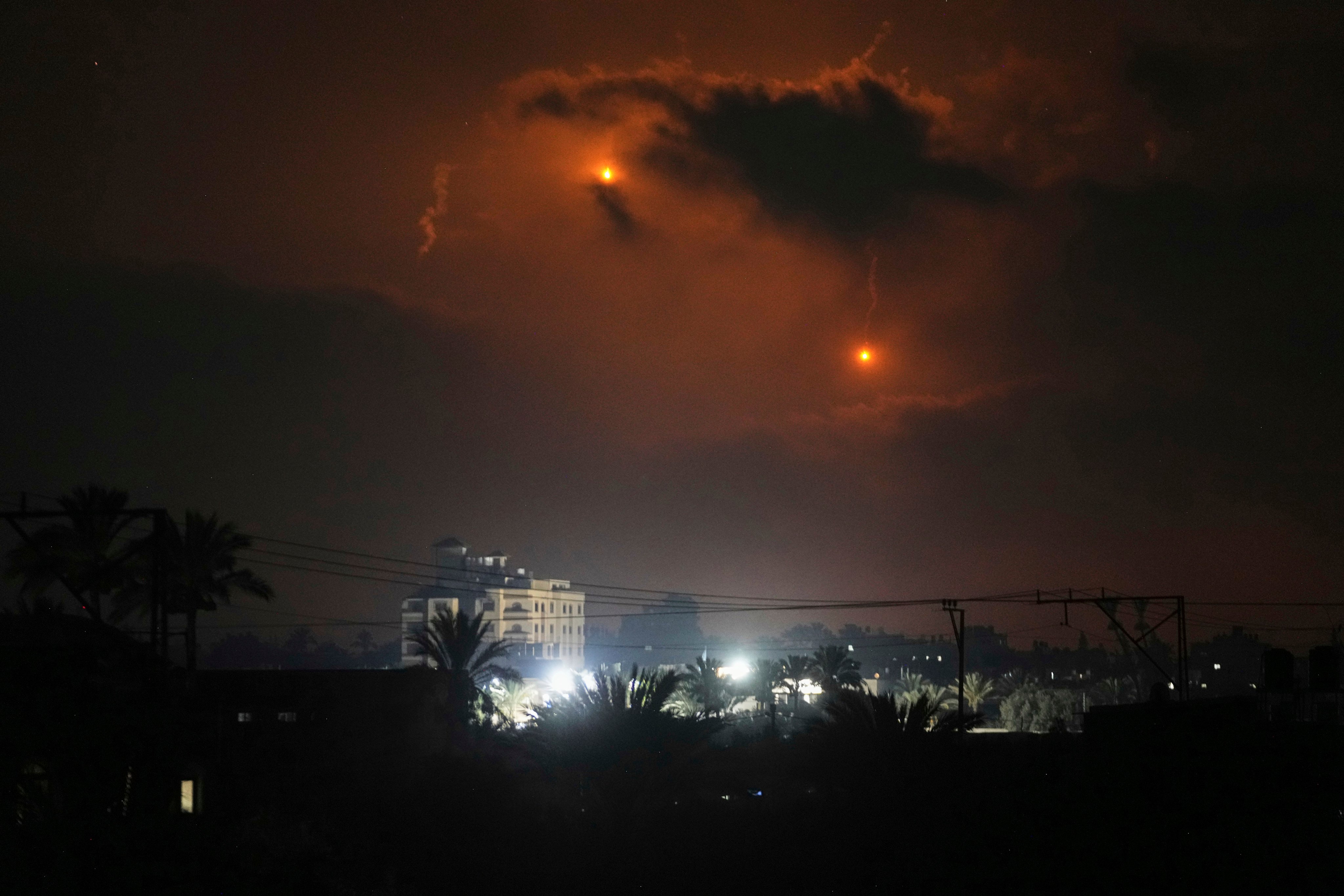 Illumination flares launched by the Israeli army over Deir al-Balah in central Gaza on Monday. Photo: AP