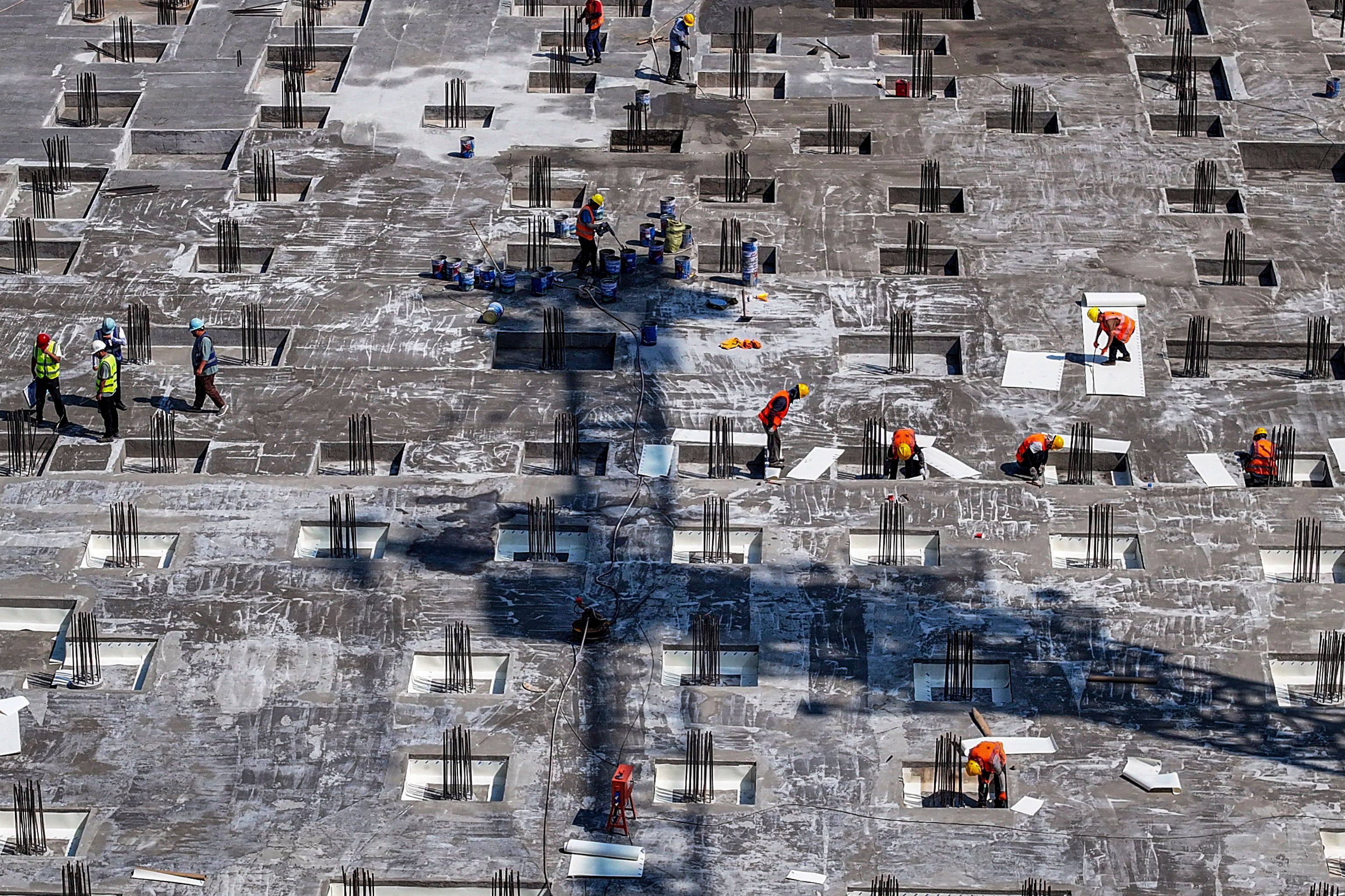 Workers at the construction site of a residential housing complex in Huaian, China. Photo: AFP