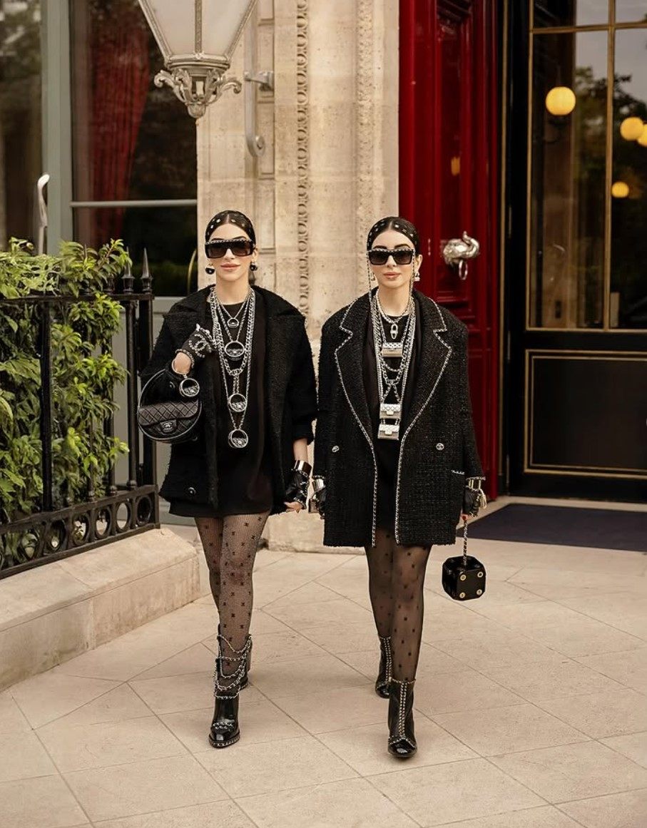 Snehal and Jyoti Babani, aka Snejyo, in black Chanel outfits. Photo: @snejyo/Instagram