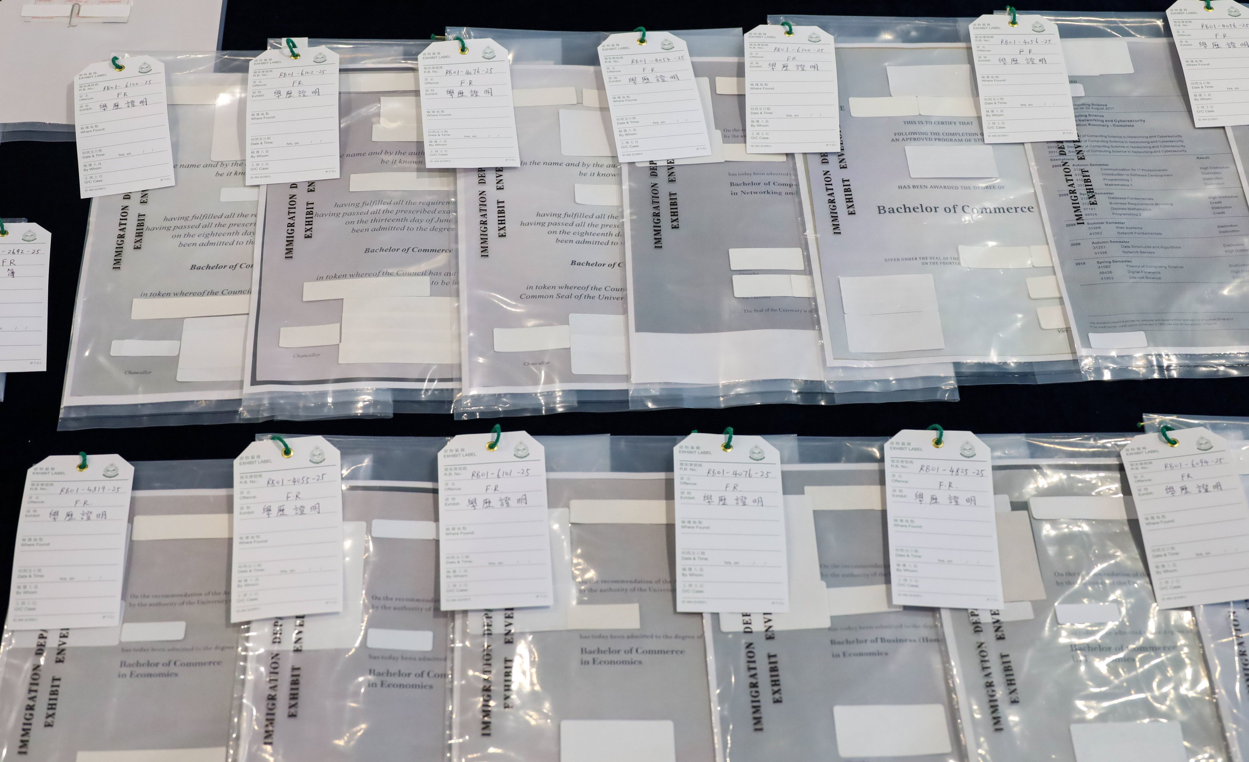 Some of the forged documents displayed as evidence. Authorities estimate that the group has worked on at least 22 talent scheme applications. Photo: Handout