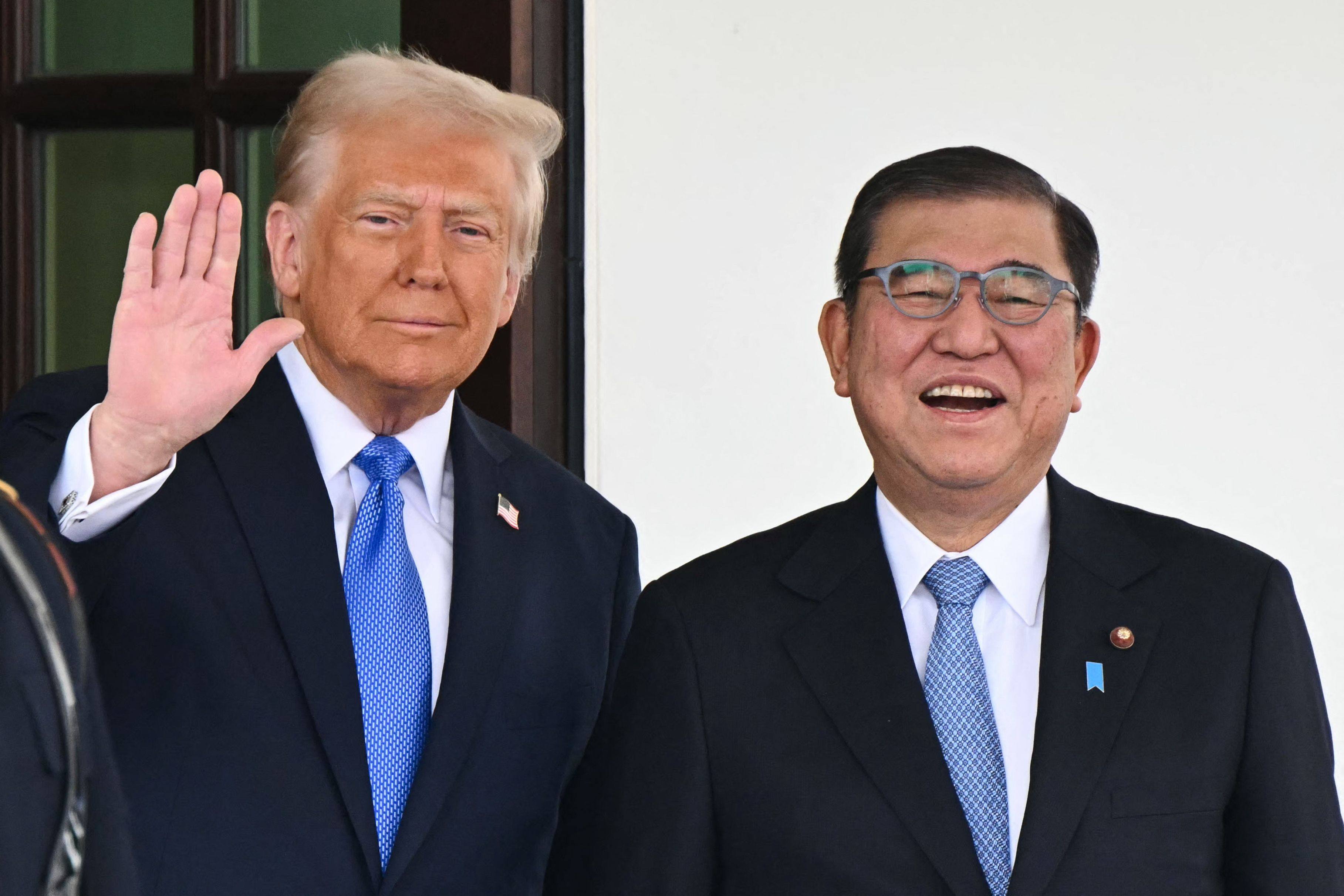 US President Donald Trump waves as he greets Japanese Prime Minister Shigeru Ishiba at the White House in February. The US and Japan have agreed on a new trade deal. Photo: AFP