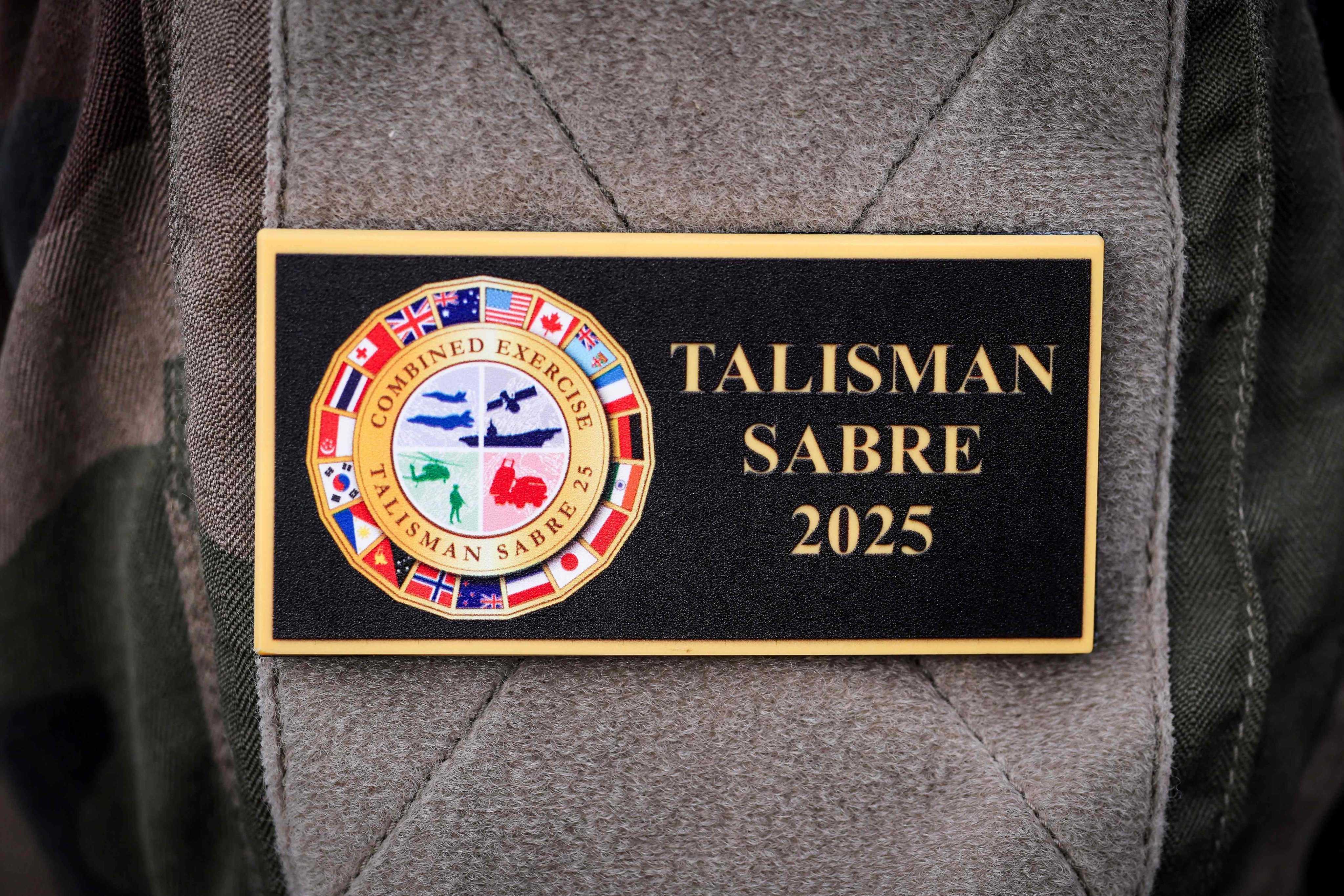 A servicemen wears a badge displaying the emblem of the 2025 Talisman Sabre exercise in Sydney earlier this month. Photo: AFP