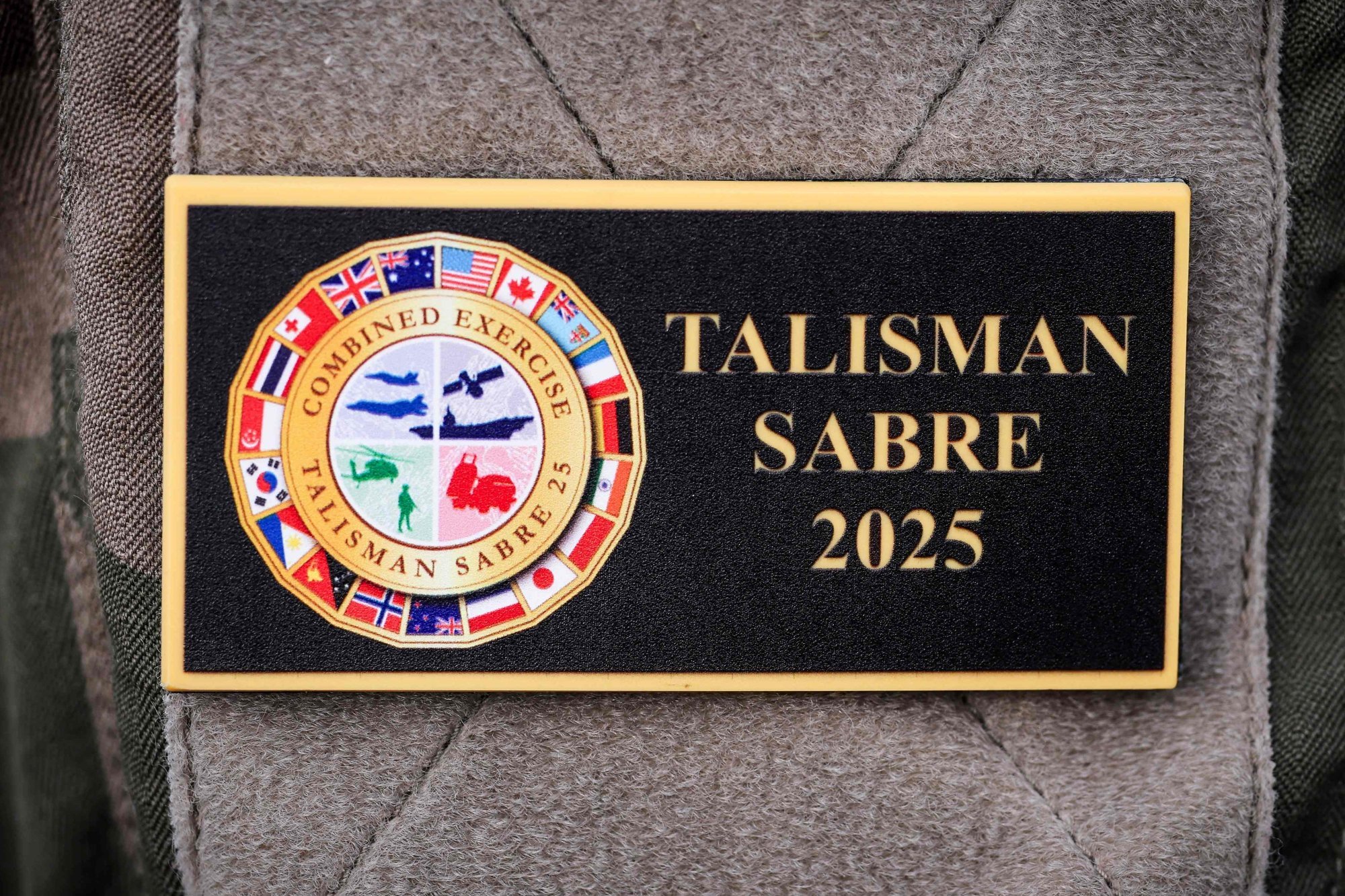 A French serviceman wears a badge displaying the emblem of the 2025 Talisman Sabre exercise aboard the French patrol vessel Auguste Benebig in Sydney on July 13. Photo: AFP