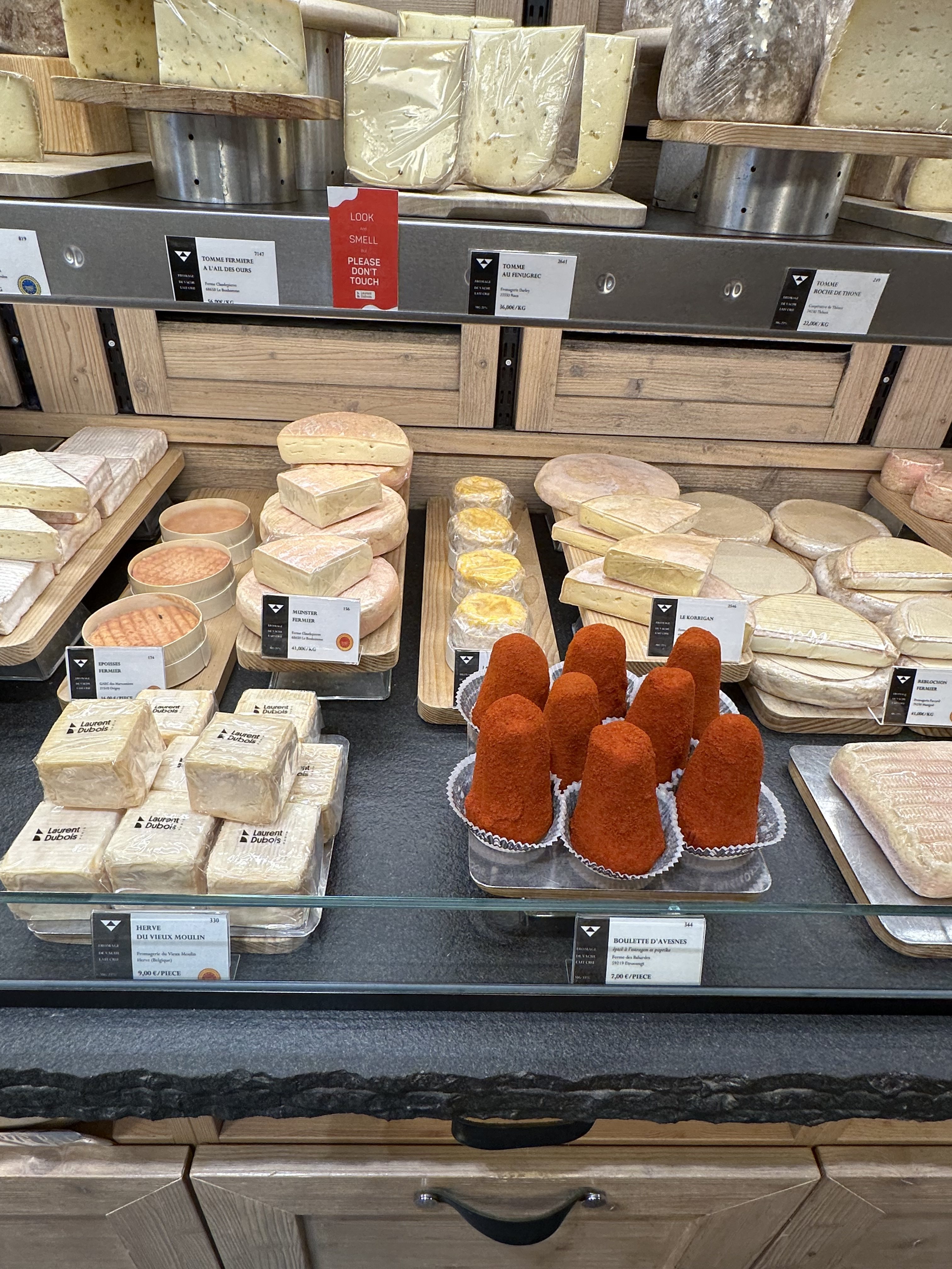 At Fromagerie Laurent Dubois in Paris, prominently placed signs advise English-speaking customers of the protocol: “Look. Smell. Please don’t touch.” Photo: Deborah L. Jacobs