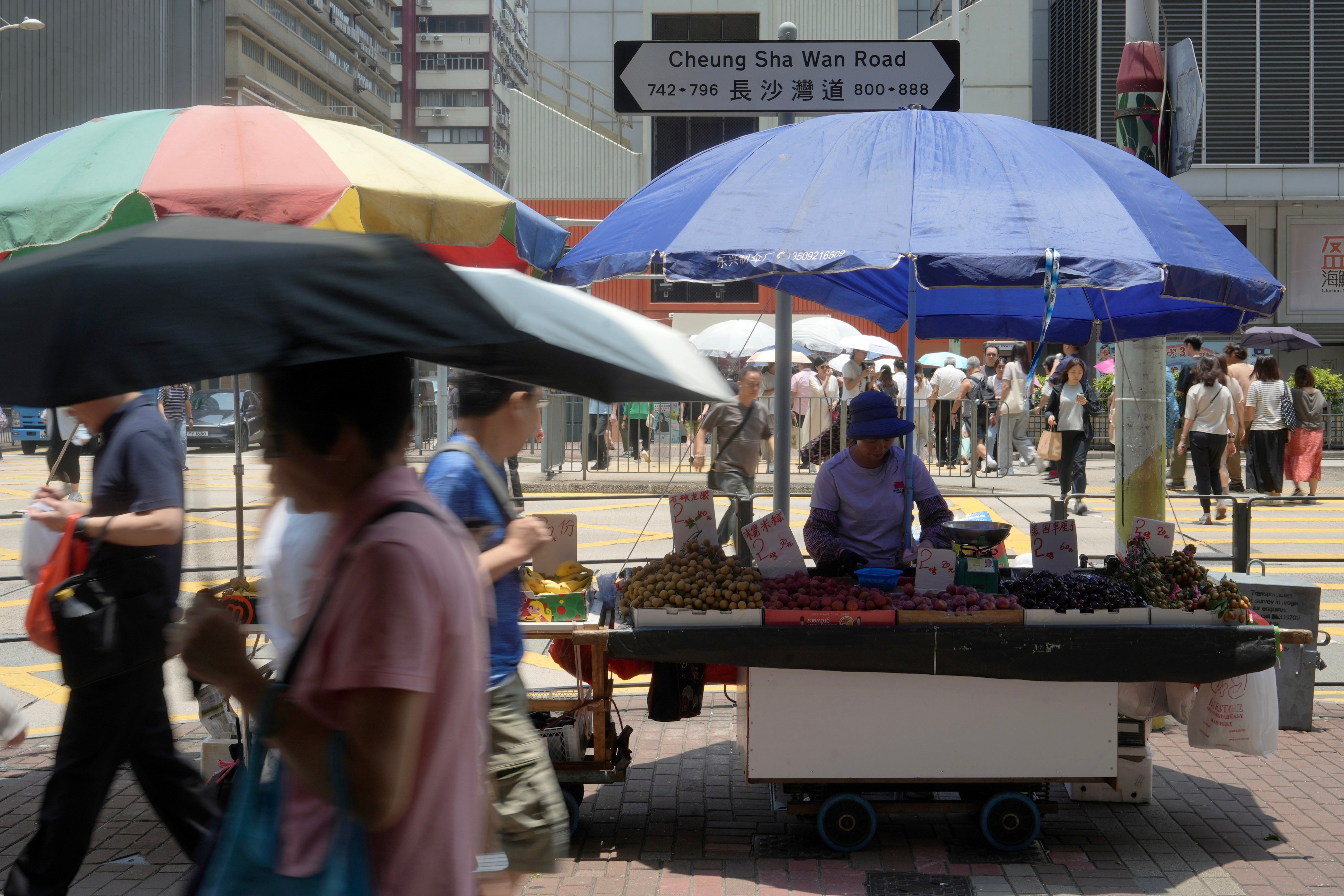 Ninety-two-year-old licensed hawker Chan Tak-ching tends to her stall in Hong Kong’s Lai Chi Kok district on July 7. Hong Kong should heed calls to revamp its rules governing hawker licences. Photo: Sun Yeung
