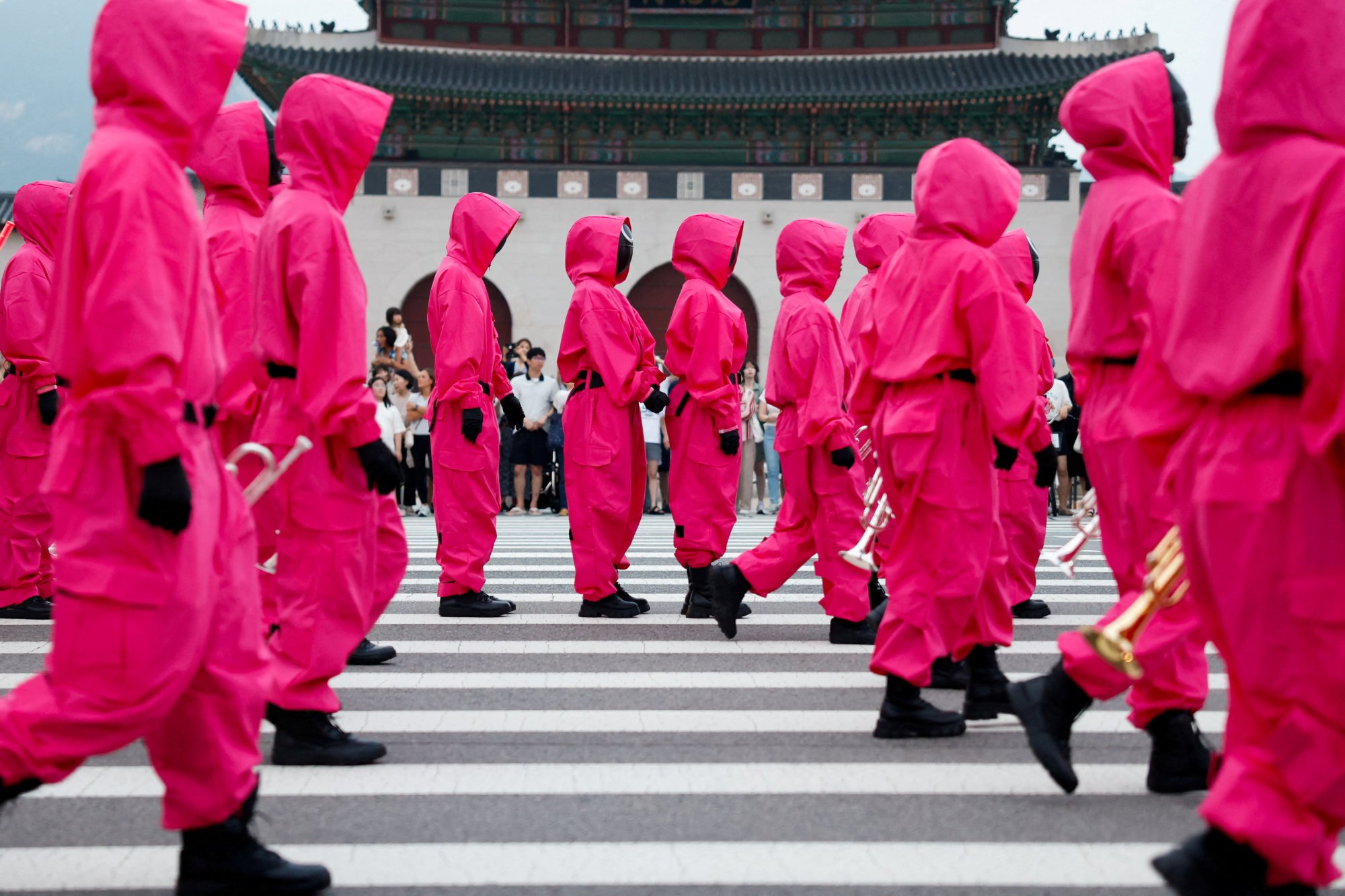 Squid Game soldiers march through central Seoul in June. The Netflix hit is seen as mirroring the debt problems faced by many South Koreans. Photo: Reuters Squid Game soldiers march through central Seoul in June. The Netflix hit is seen as mirroring the debt problems faced by many South Koreans. Photo: Reuters