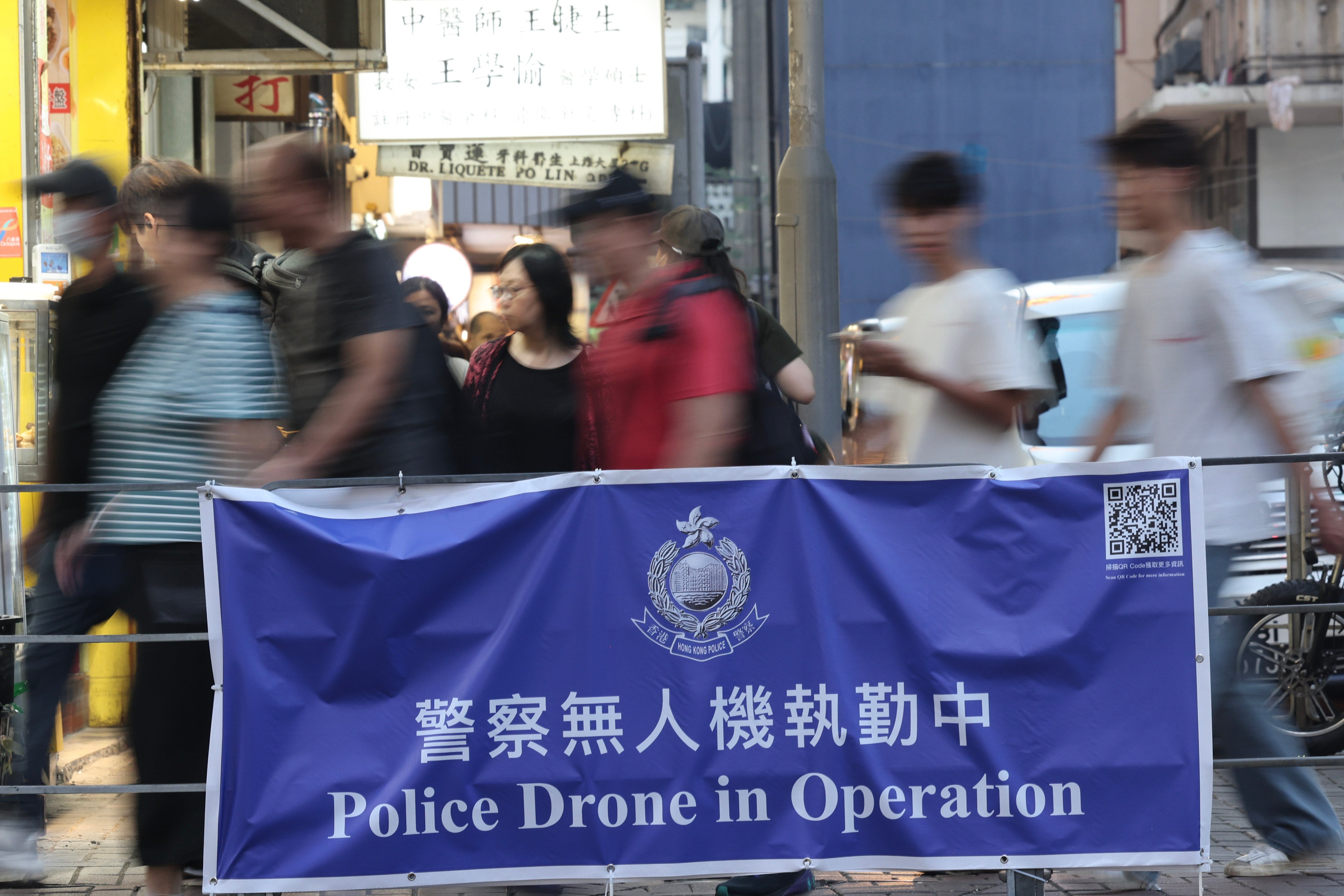 A banner reading “Police Drone in Operation” is displayed in Yau Ma Tei on June 6. The normalisation of exploitative moneylending erodes trust in Hong Kong’s financial and legal systems. Photo: Jelly Tse