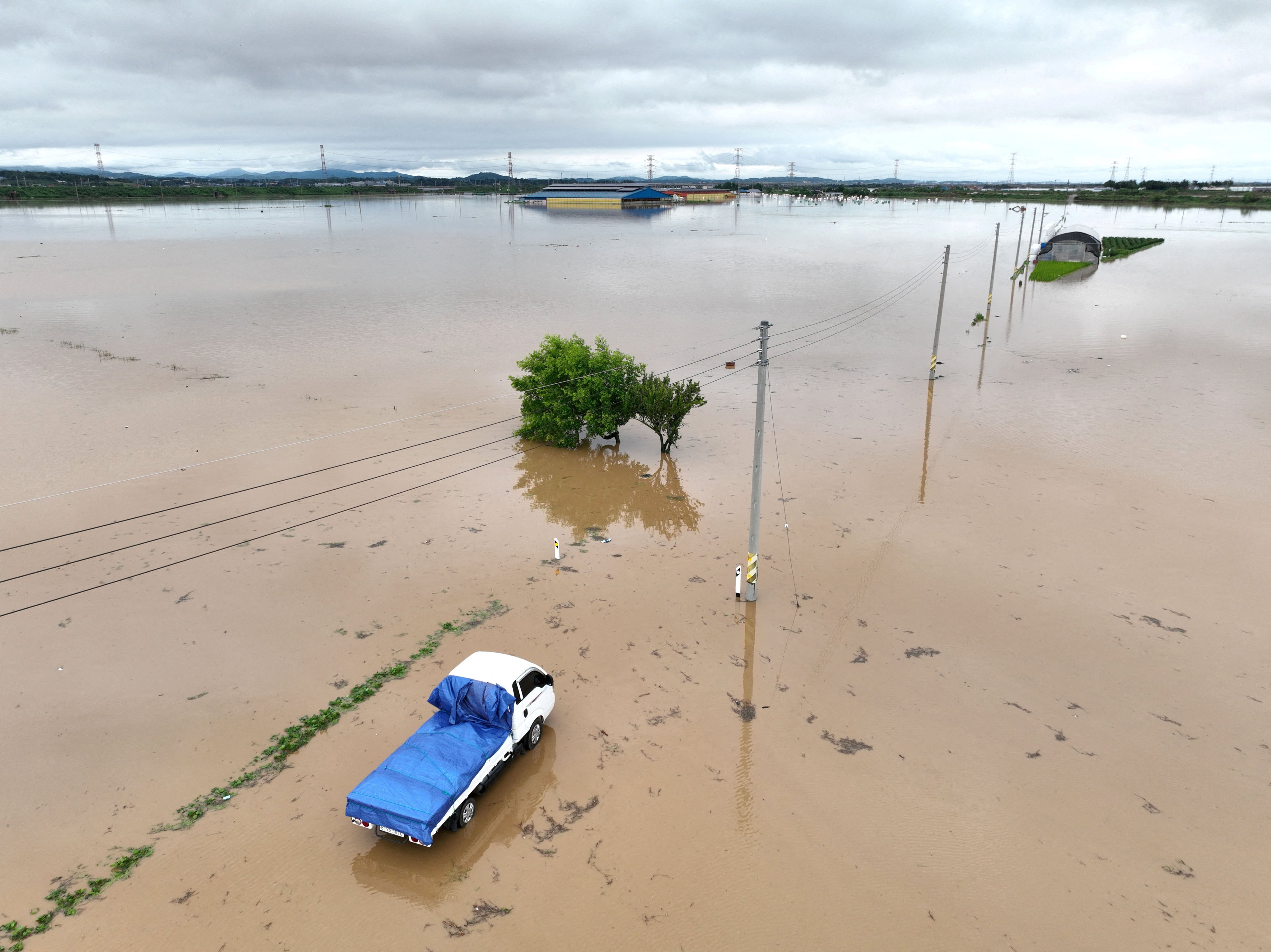 A flooded road caused by torrential rain in Yesan, South Korea. Photo: Yonhap via Reuters