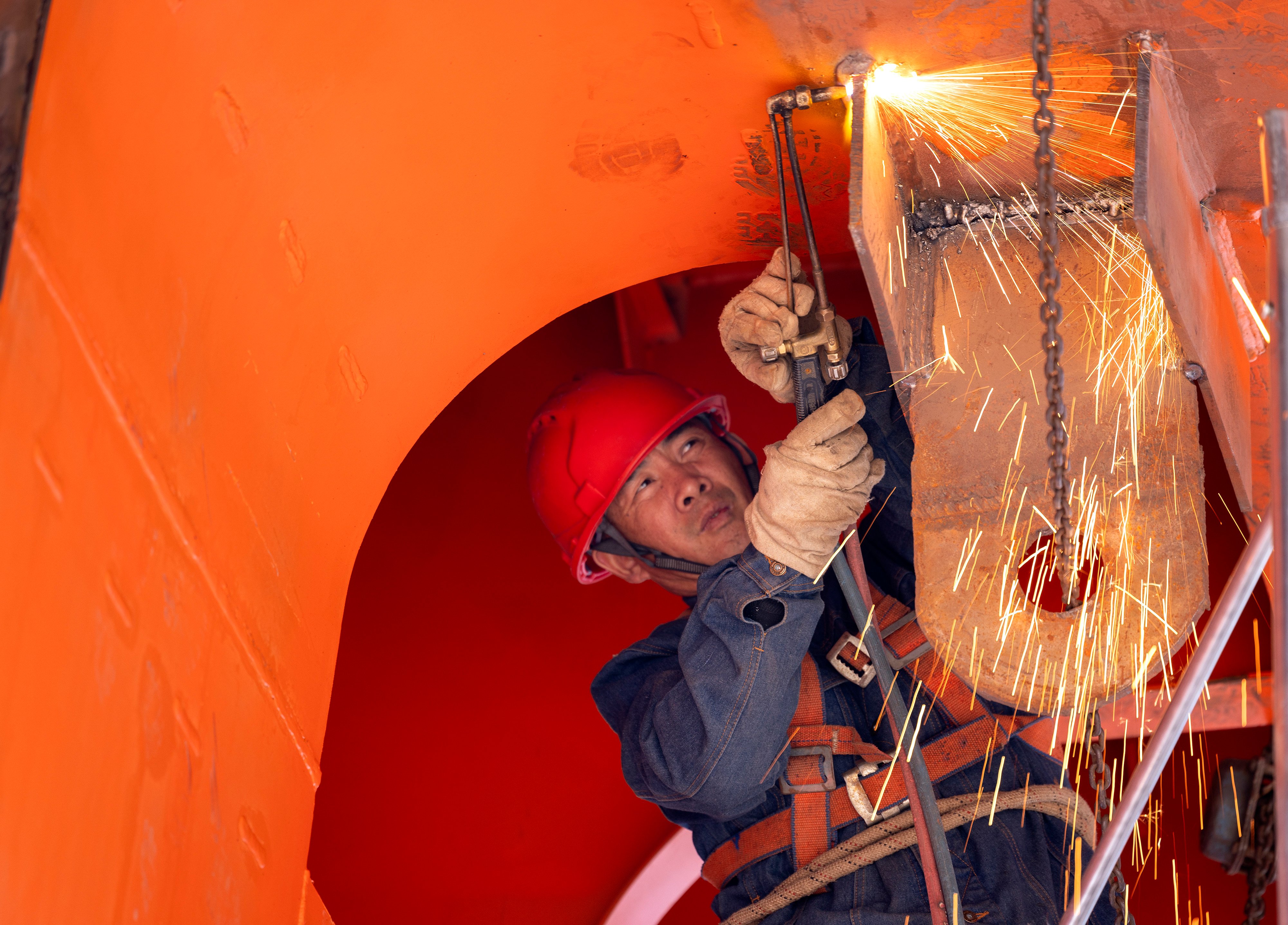 A worker welds on a cargo vessel at a shipbuilding base in China’s Hubei province. Photo: Getty Images