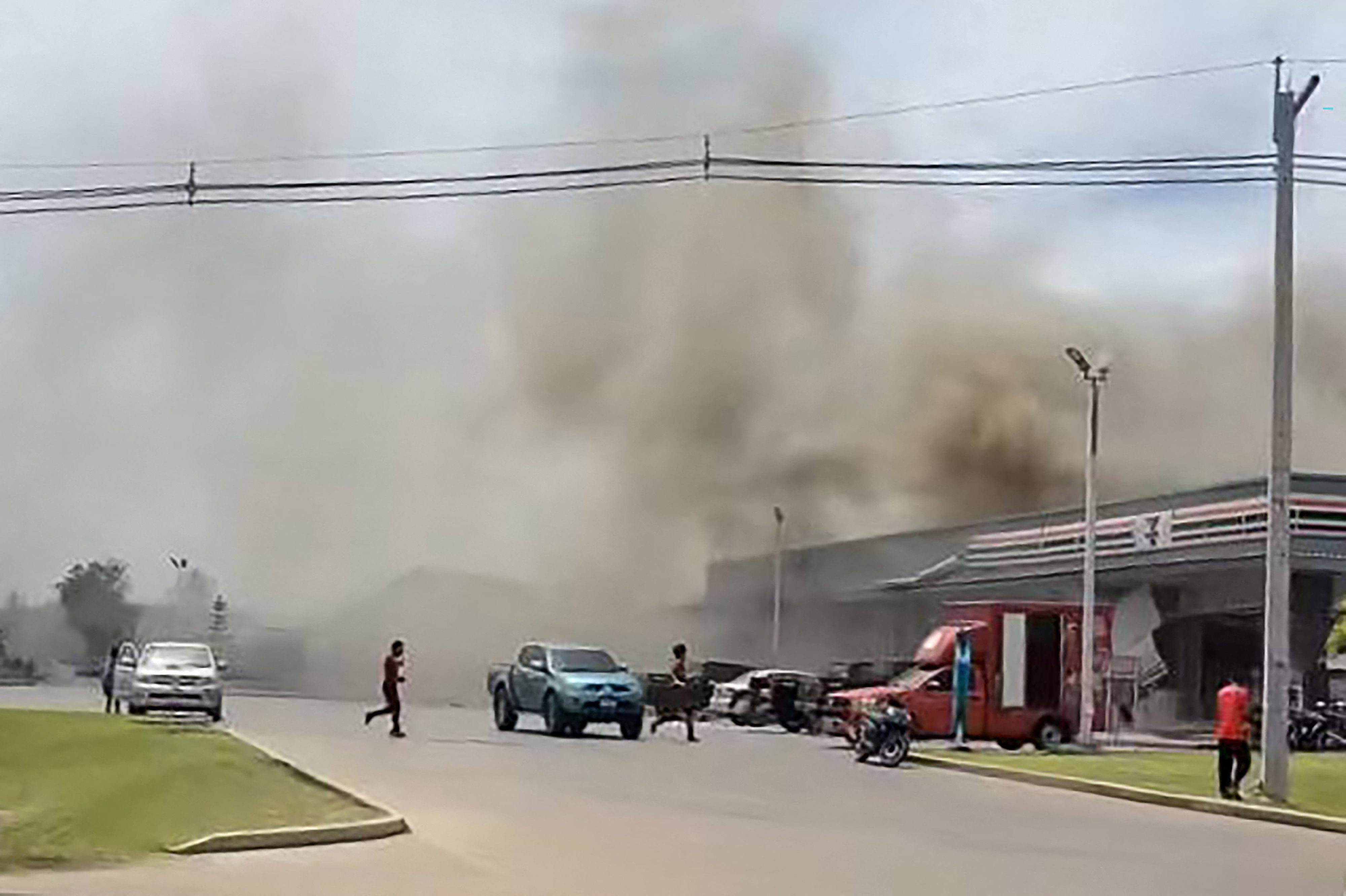 Smoke billows from the roof of a convenience store attached to a petrol station in Thailand’s Sisaket province after it was hit by a rocket strike from Cambodia on Thursday. Photo: Facebook/ Chatchak Ratsamikaeo / AFP