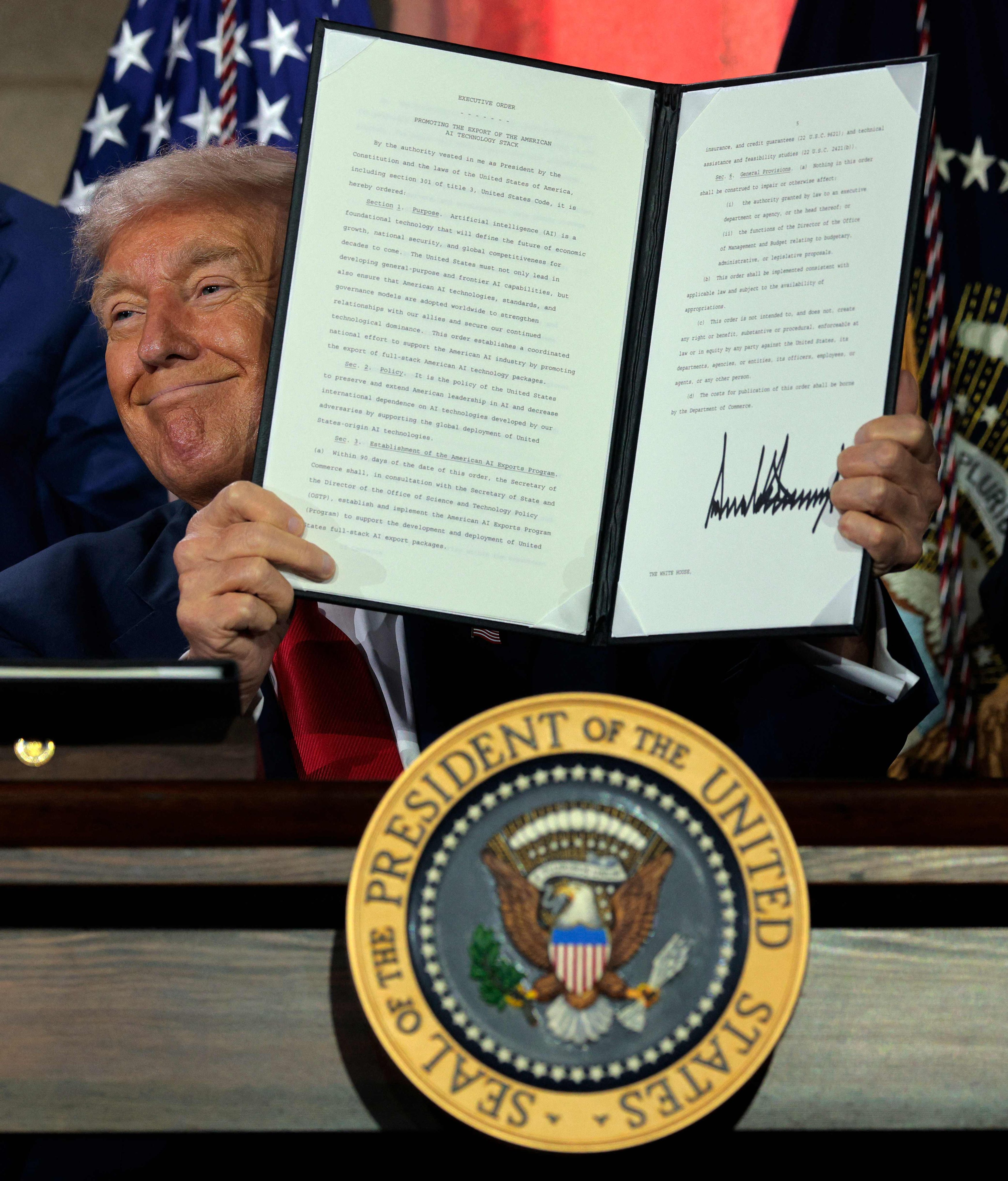 US President Donald Trump displays a signed executive order at an AI summit in Washington on Wednesday, where he discussed his administration’s strategy to outcompete China on artificial intelligence. Photo: AFP
