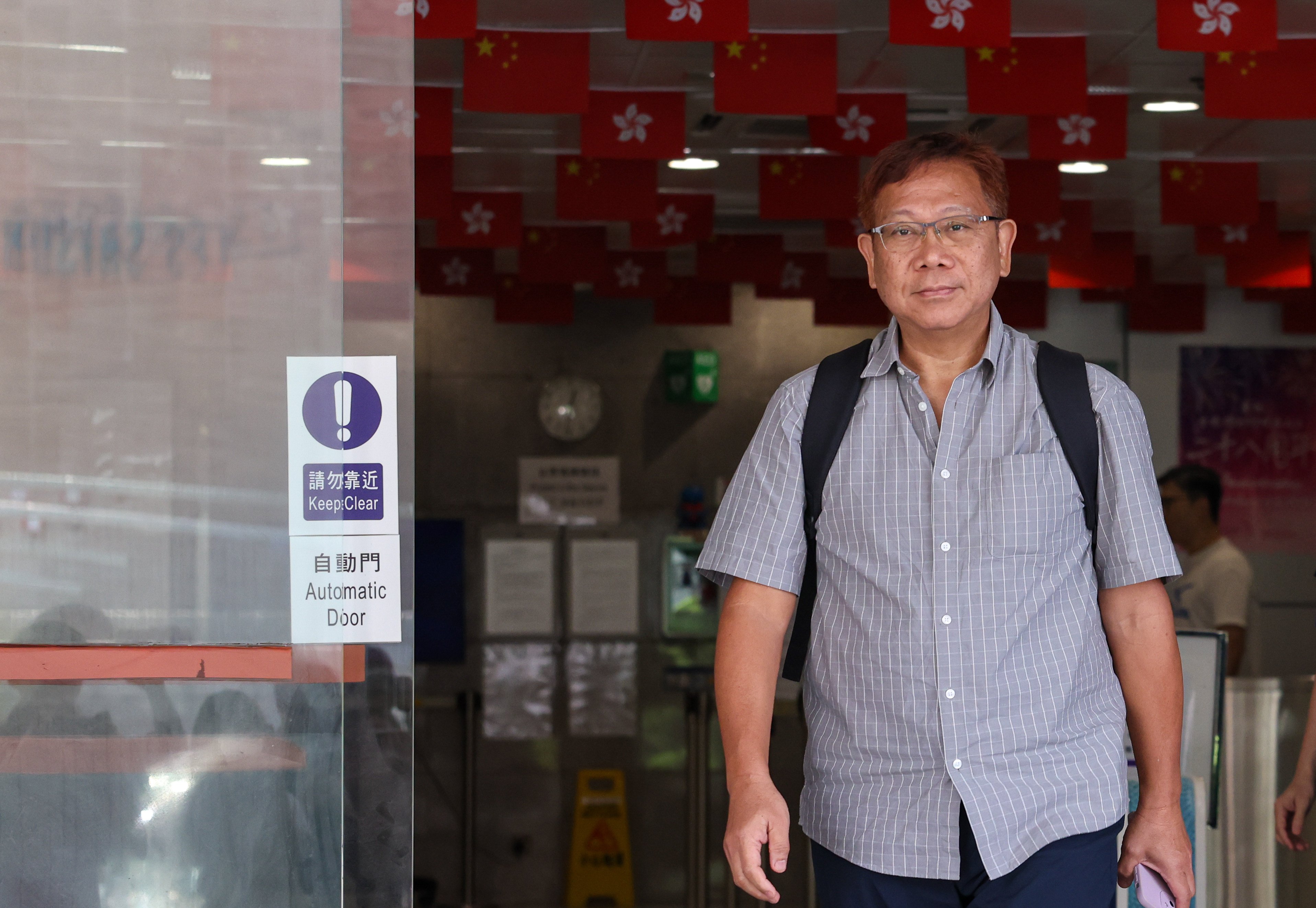 Social worker Eddie Tse leaves Eastern Court after being sentenced to community service for defrauding authorities. Photo: Brian Wong