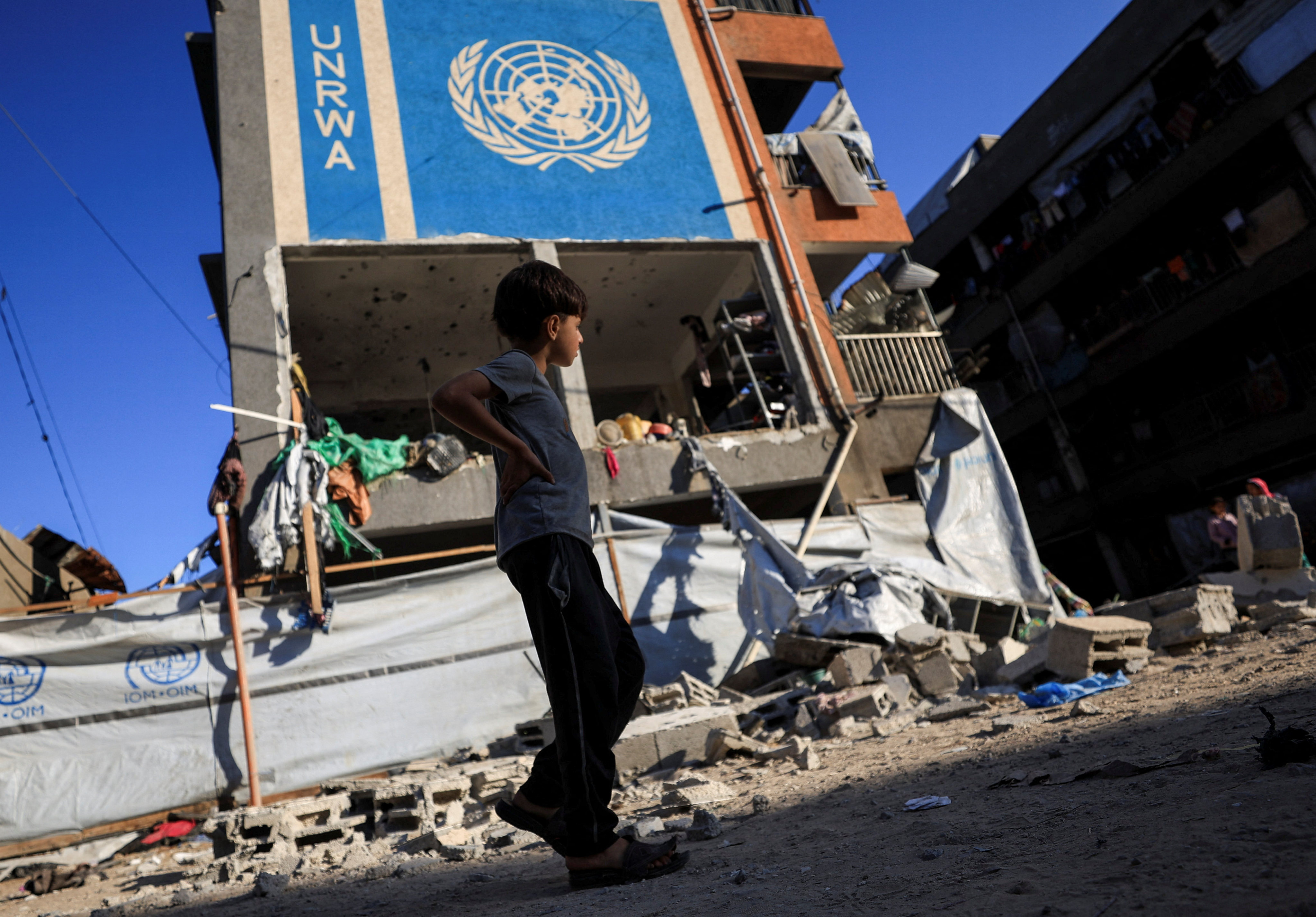 A Palestinian boy walks near an United Nations Relief and Works Agency for Palestine Refugees in the Near East (UNRWA) school sheltering displaced people that was hit in an overnight Israeli strike, in Gaza City on July 5. Photo: Reuters