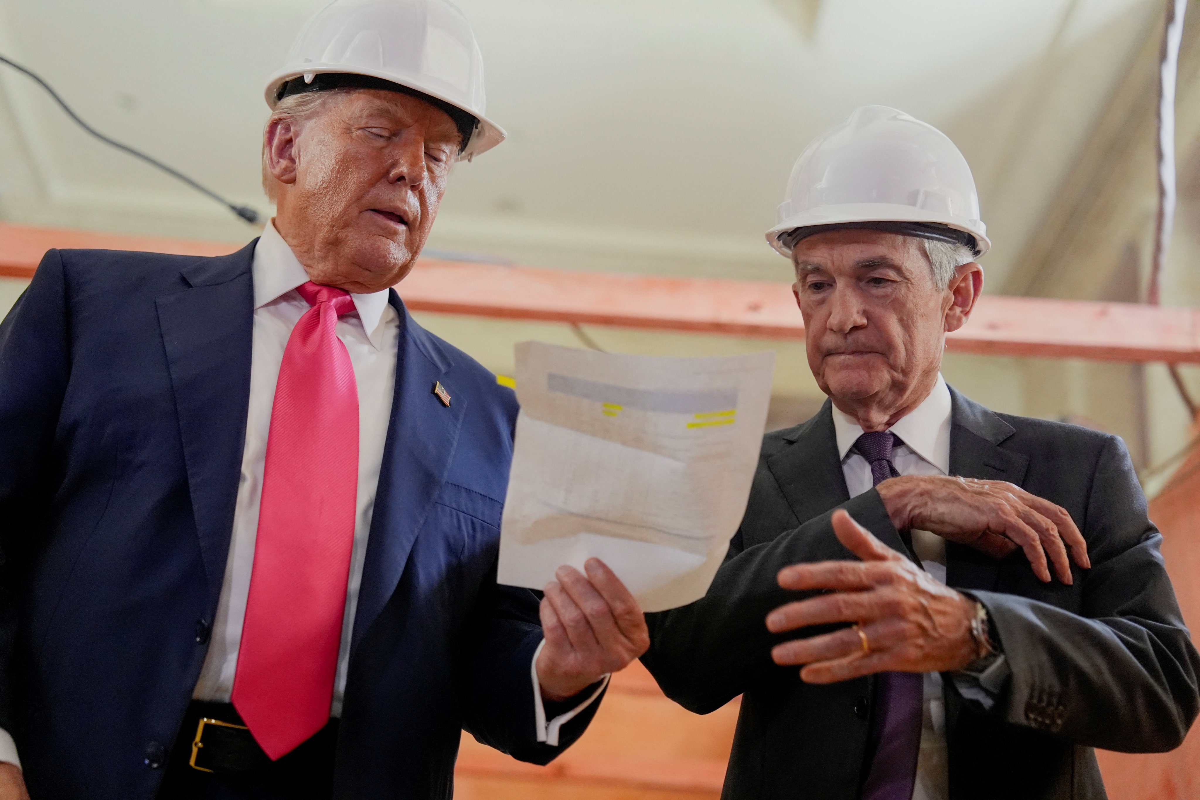 US President Donald Trump (left) passes a document to Federal Reserve Chair Jerome Powell during a tour of the Federal Reserve Board building on Thursday. Photo: Reuters
