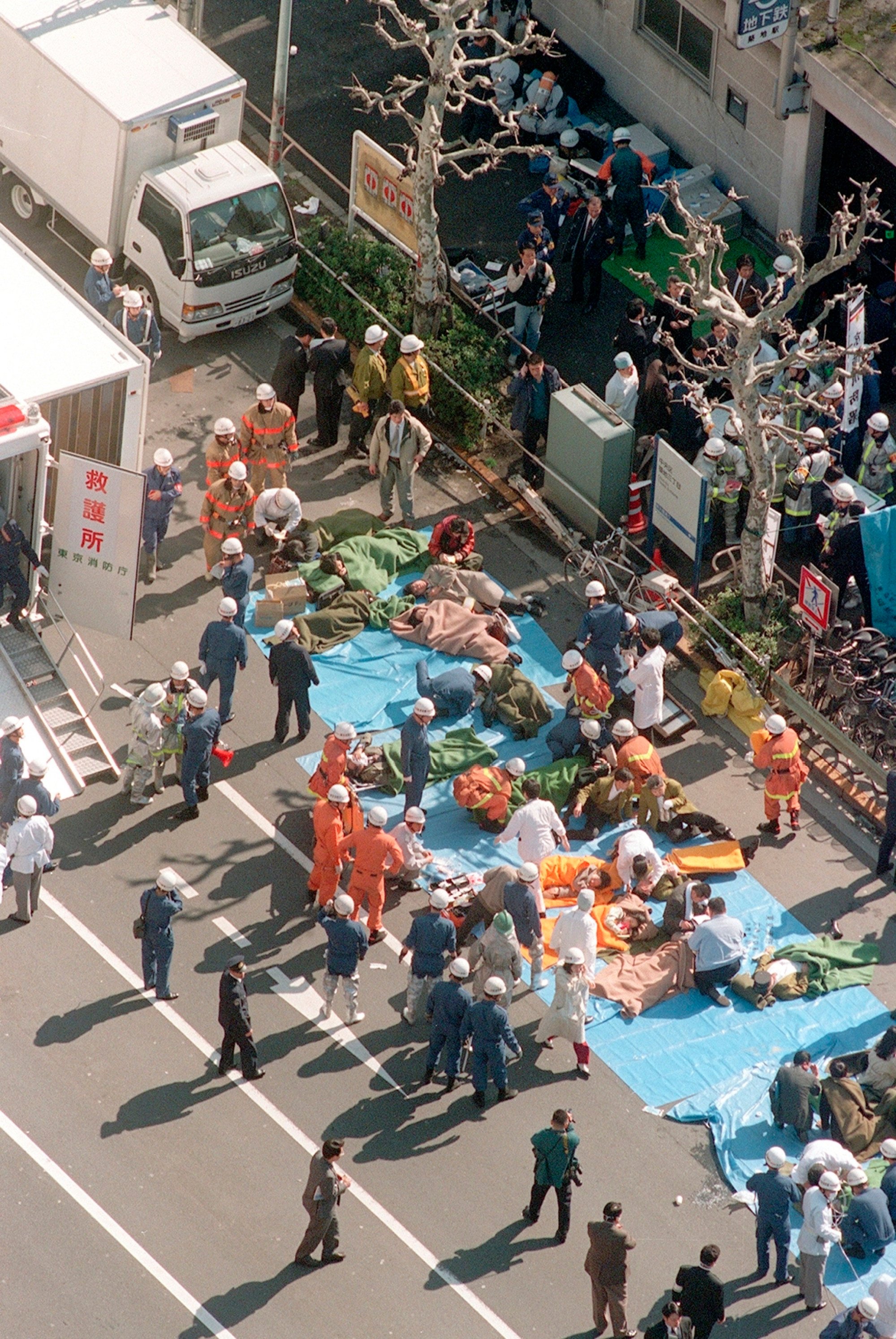Subway passengers affected by sarin nerve gas are treated near Tsukiji subway station in Tokyo on March 20, 1995. Photo: Kyodo / AP