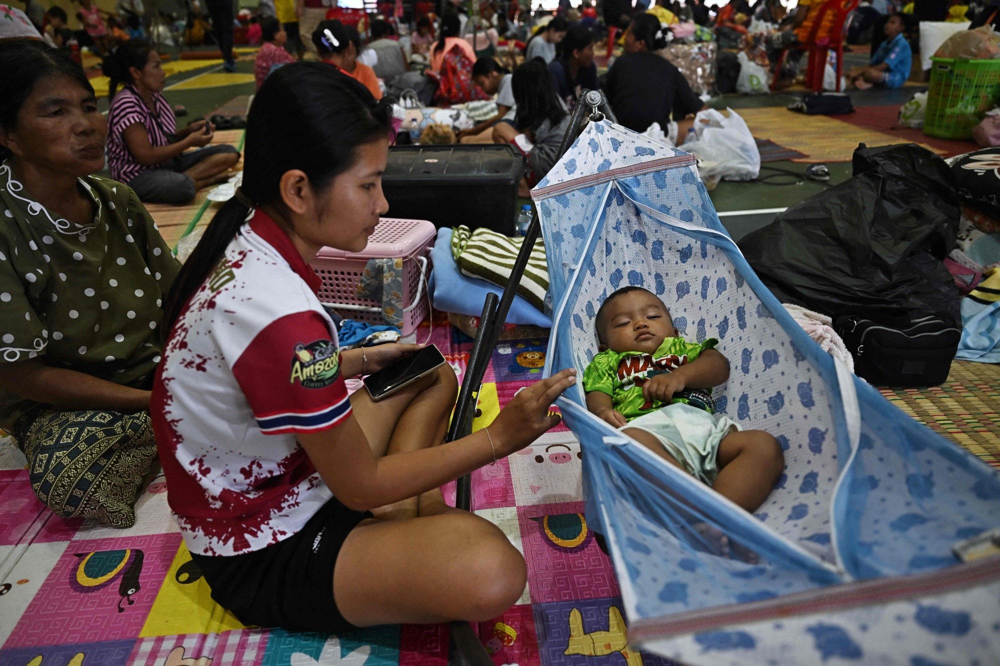 Evacuees take shelter in a gymnasium on the grounds of Surindra Rajabhat University in the Thai border province of Surin on Friday. Photo: AFP Evacuees take shelter in a gymnasium on the grounds of Surindra Rajabhat University in the Thai border province of Surin on Friday. Photo: AFP