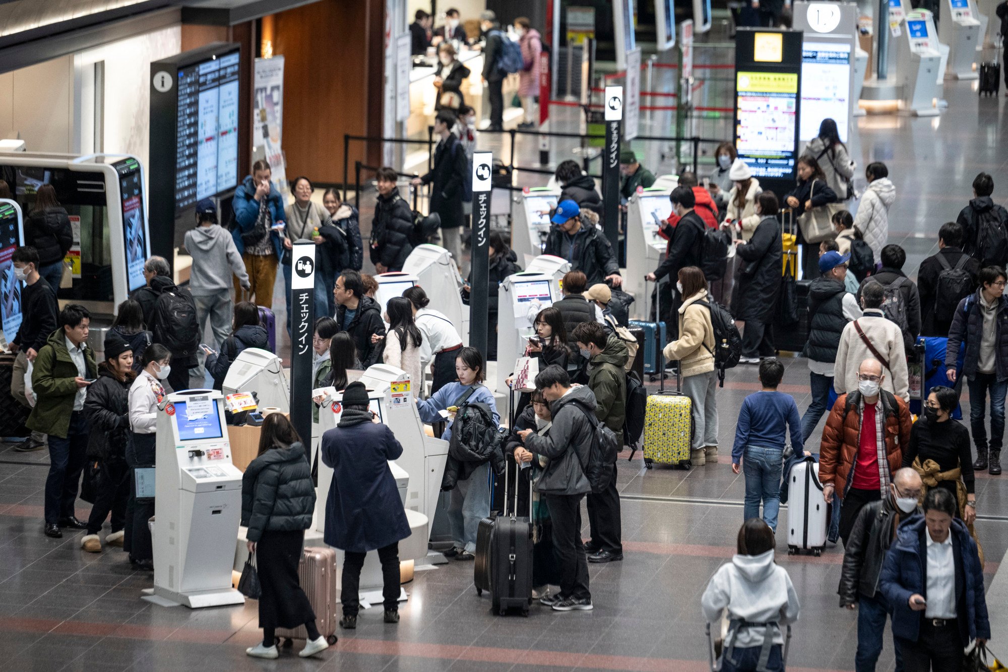 People wait to check in at the departure hall of Haneda Airport in Tokyo. A recent study has placed Japan well behind several developed economies in terms of international travel readiness. Photo: AFP