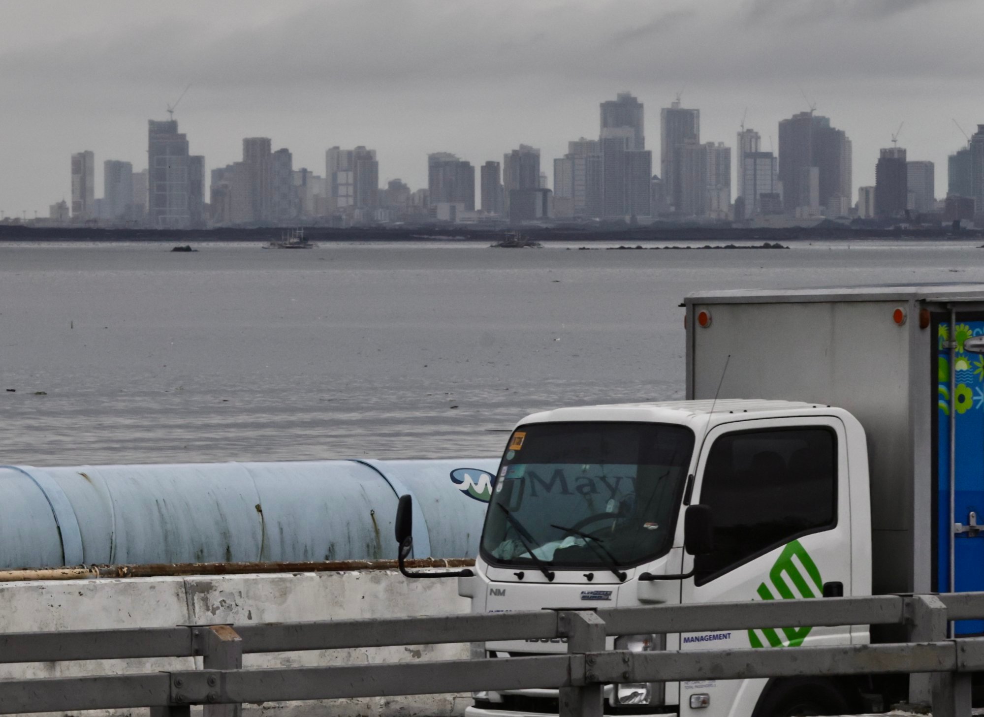 A container truck drives past the Manila skyline on Wednesday. The Philippines secured a modest tariff reduction following President Ferdinand Marcos Jnr’s visit to Washington earlier this week. Photo: EPA