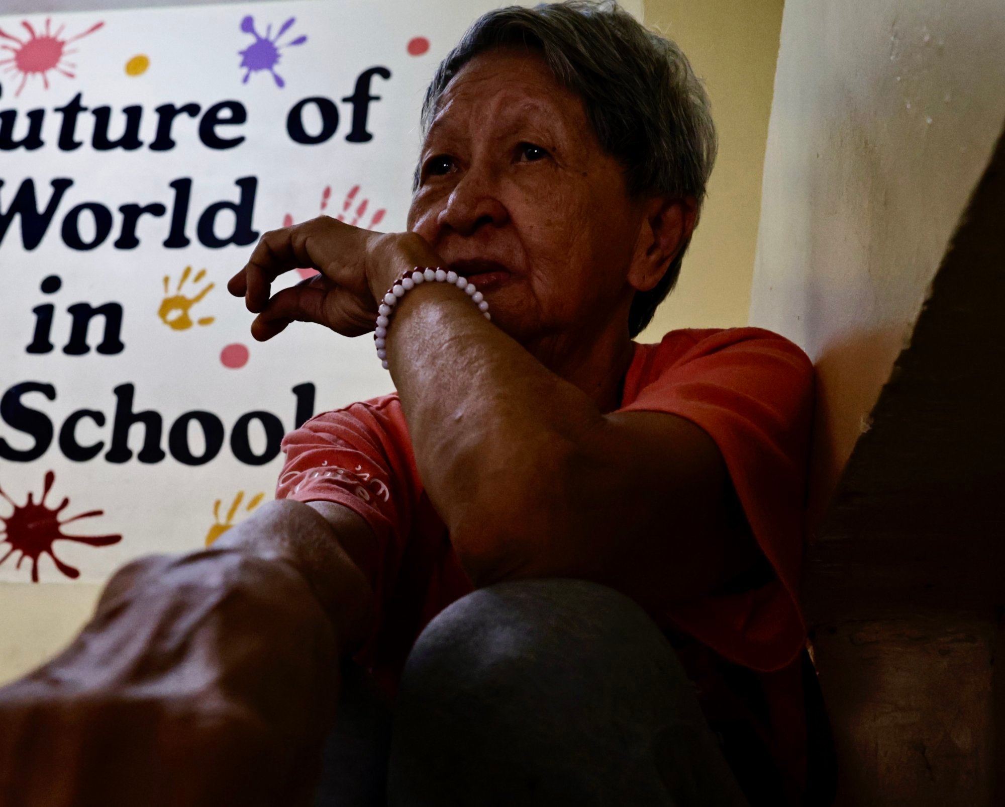 An elderly Filipino woman takes shelter inside a school building turned into a temporary evacuation centre in Manila after localised flooding last month. Photo: EPA