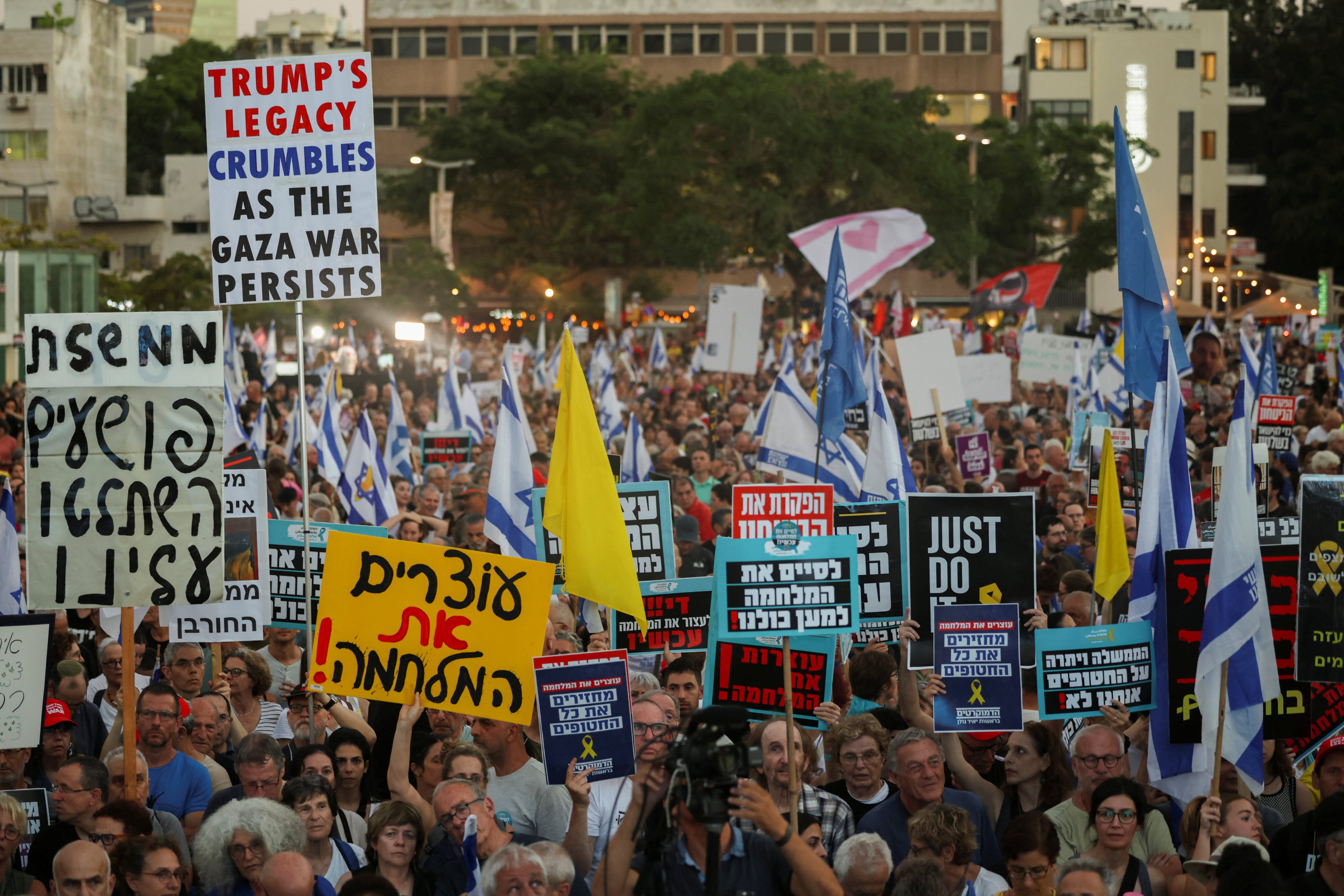 Demonstrators in Tel Aviv, Israel, on Thursday hold signs demanding an end to the war in Gaza and the release of all hostages. Photo: Reuters