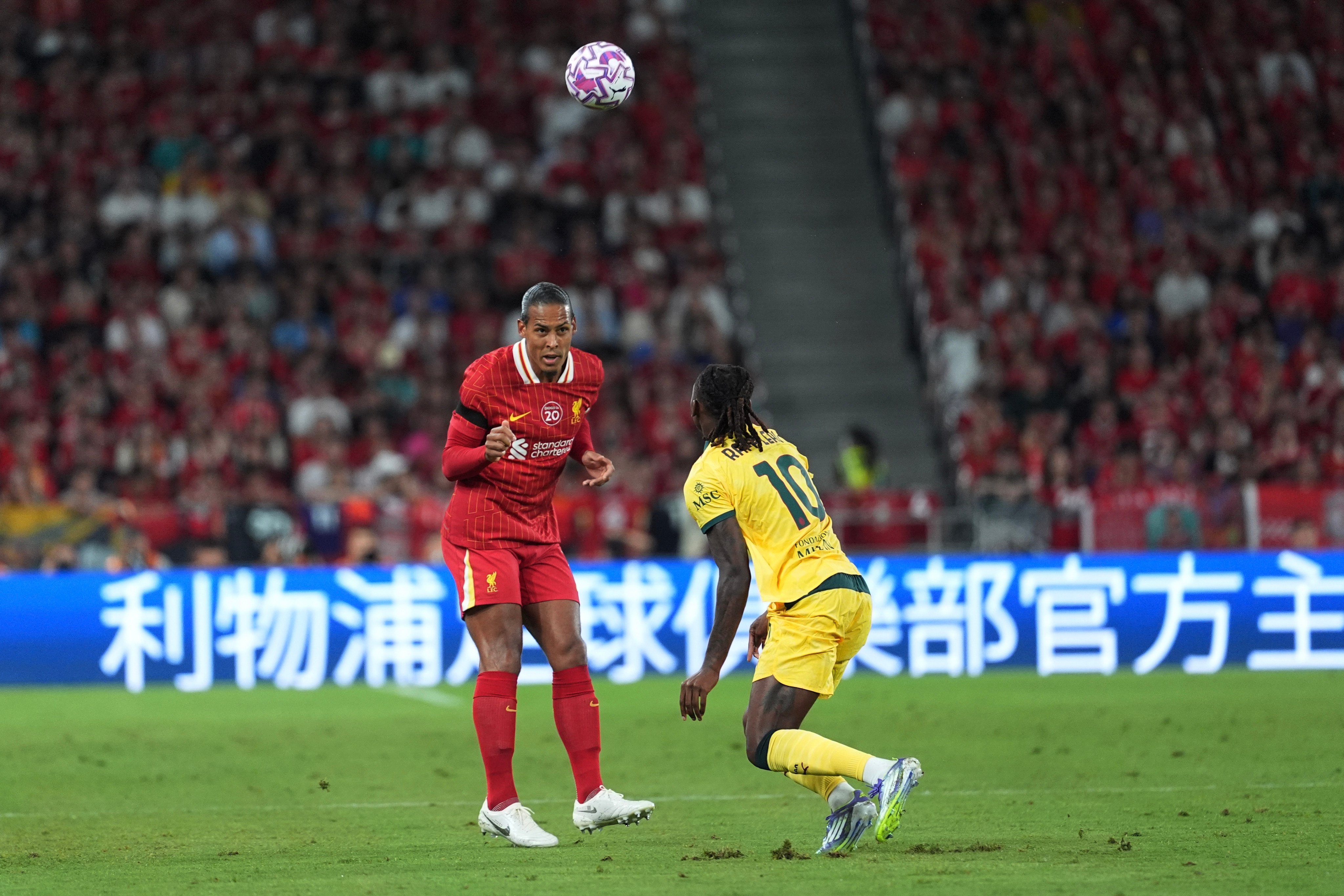Liverpool’s Virgil van Dijk heads the ball during the match against AC Milan. Photo: Elson Li