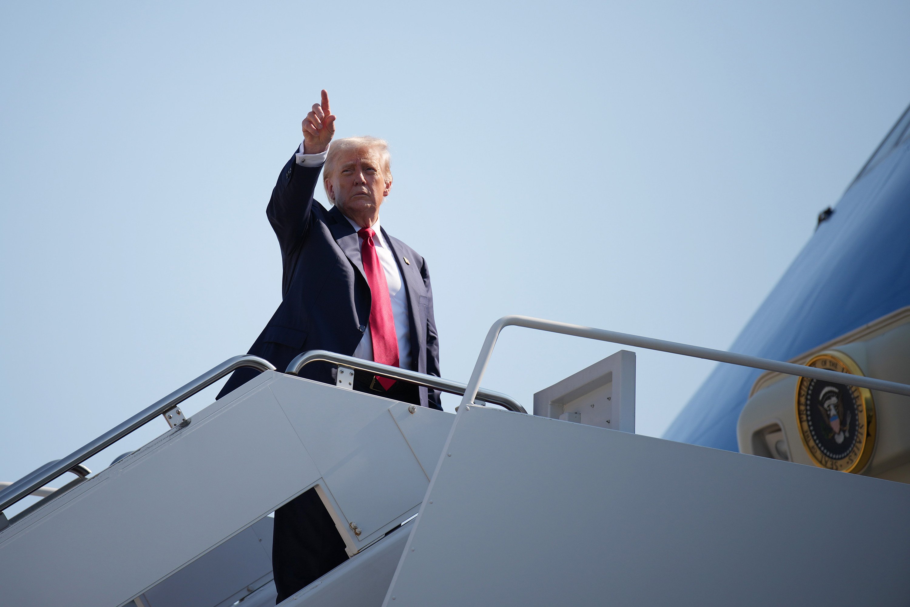 US President Donald Trump boards Air Force One at Joint Base Andrews, Maryland, on Friday before leaving for Scotland. Photo: TNS